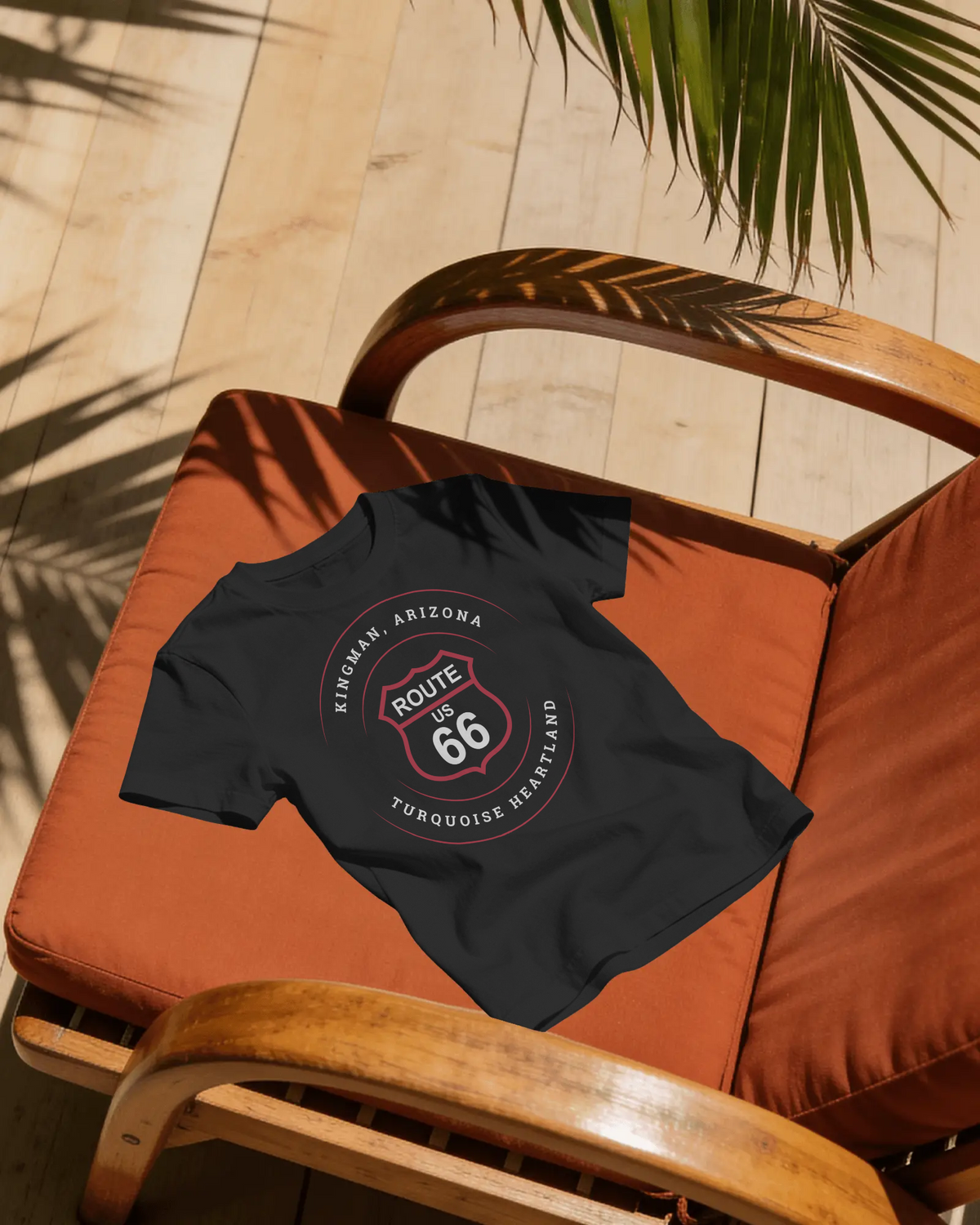 Kingman Arizona turquoise heartland Route 66 t-shirt in black, flat lay on patio chair