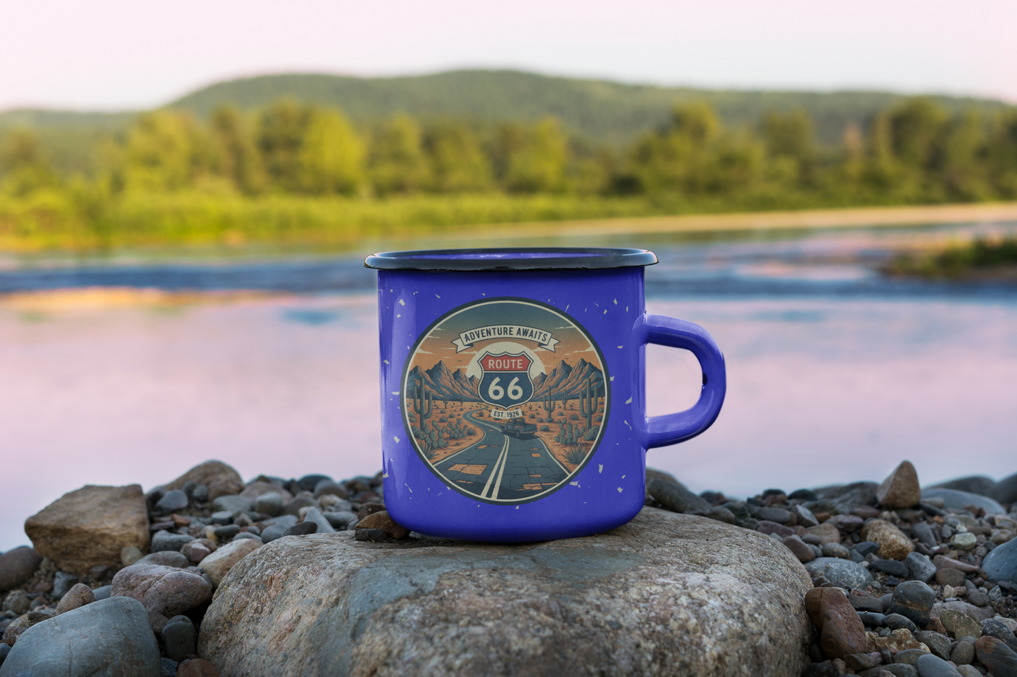 Route 66 enamel camping mug on rocks by the river - retro "Adventure Awaits" travel mug for campers and road trippers.
