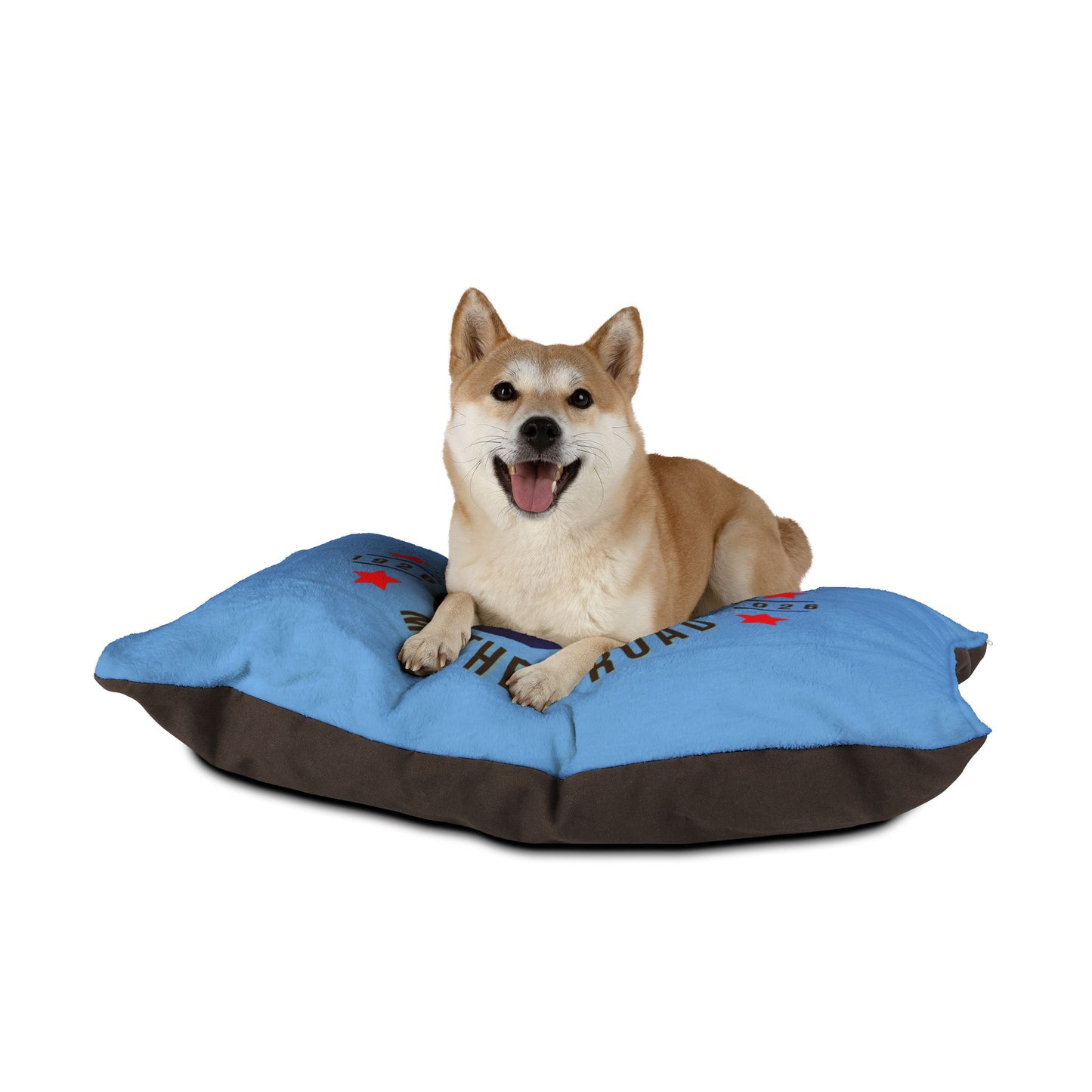 Happy dog lying on a blue Heart of the Mother Road Route 66 pet bed, showcasing soft fleece and cozy design.