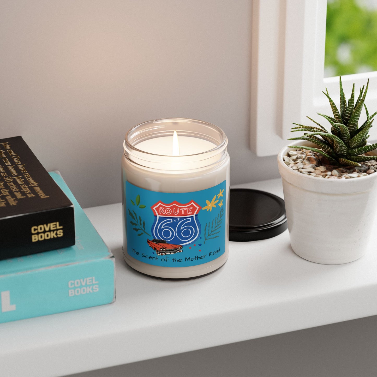 Route 66 Soy Candle burning on windowsill next to books and a succulent plant: perfect home or office décor and gift idea.