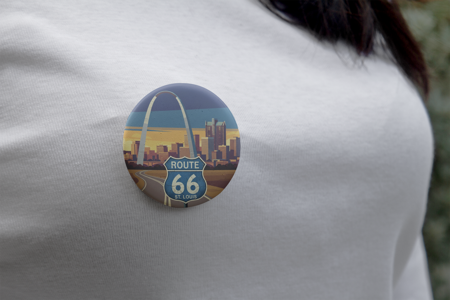 Route 66 St. Louis Gateway to the West pin button with a St Louis skyline with the arch design, worn on a white shirt.