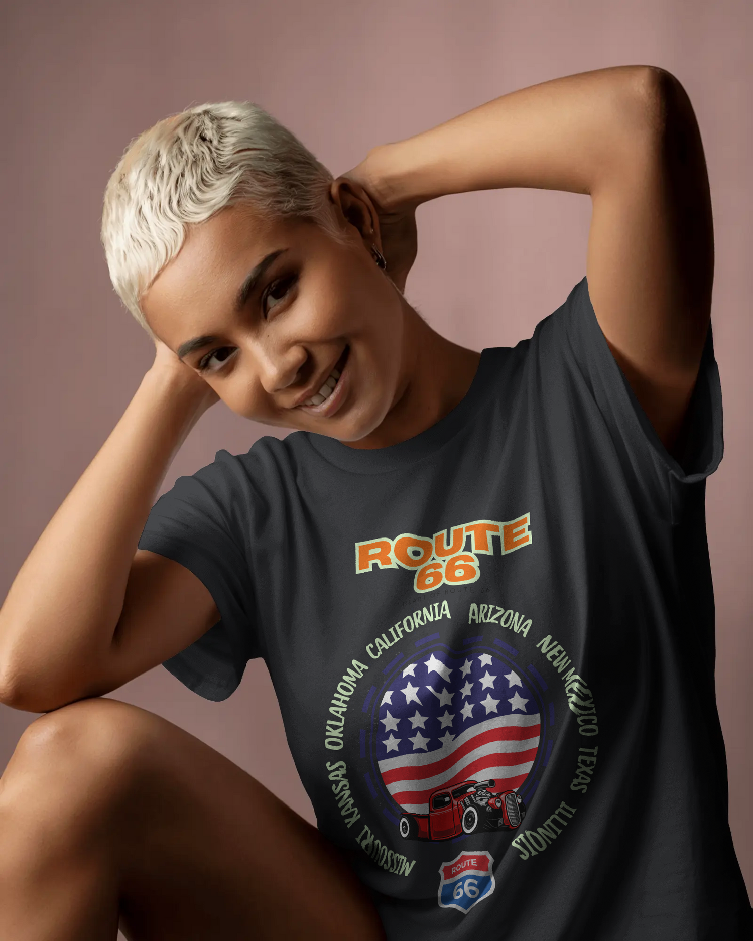 Smiling woman wearing a Route 66 t-shirt featuring a patriotic American flag and vintage car design, surrounded by all eight Route 66 states.