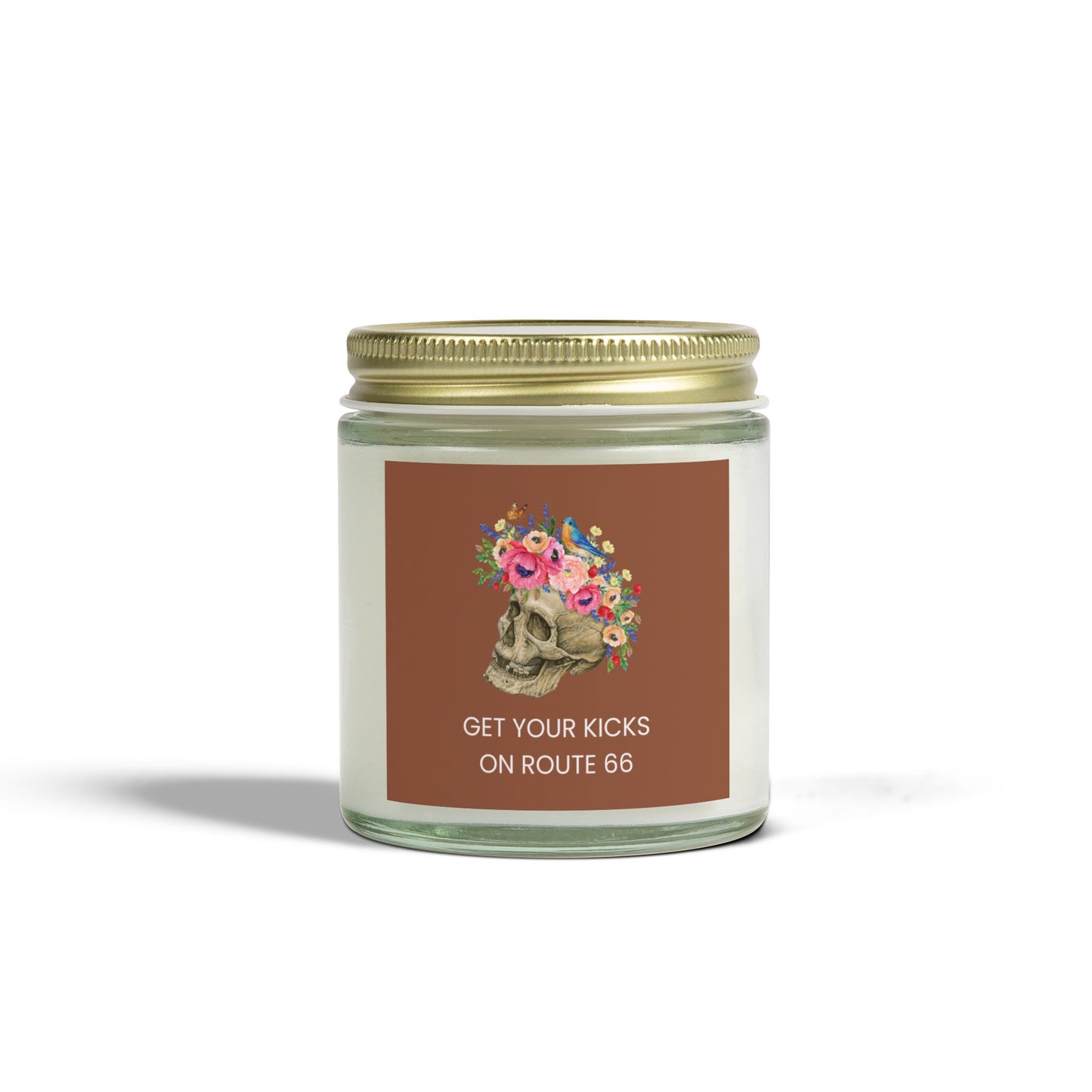 Clear glass Floral Skull Route 66 candle with floral skull label; and gold metal lid
