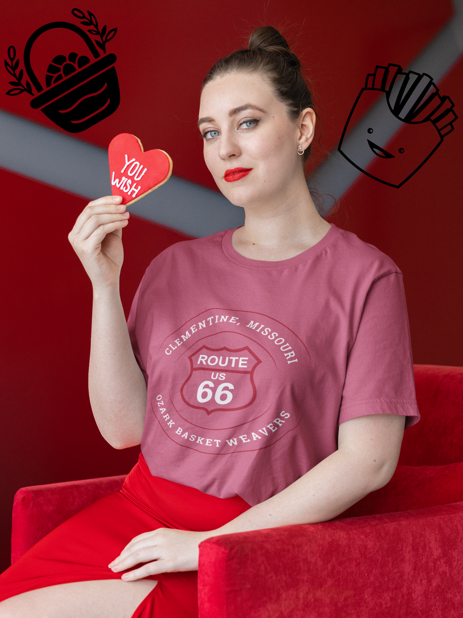 Woman holding a heart-shaped cookie, subtly smiling and wearing a 
model wearing a heather raspberry retro Route 66 unisex jersey tee with a Clementine, MO: "Ozark Basket Weavers" design