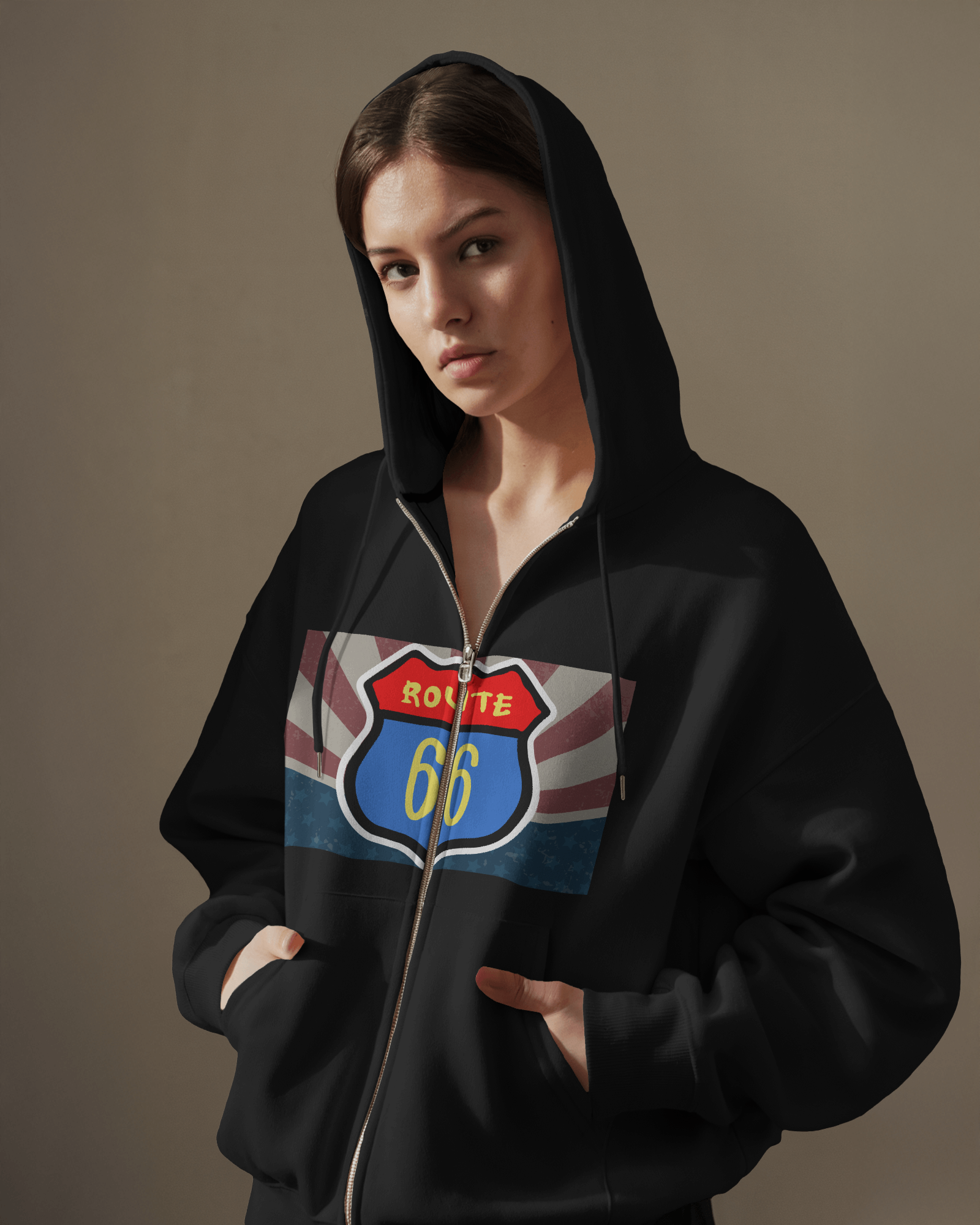Woman wearing a black Retro Route 66 zip hoodie with the hood up, featuring vintage travel-inspired highway design. 