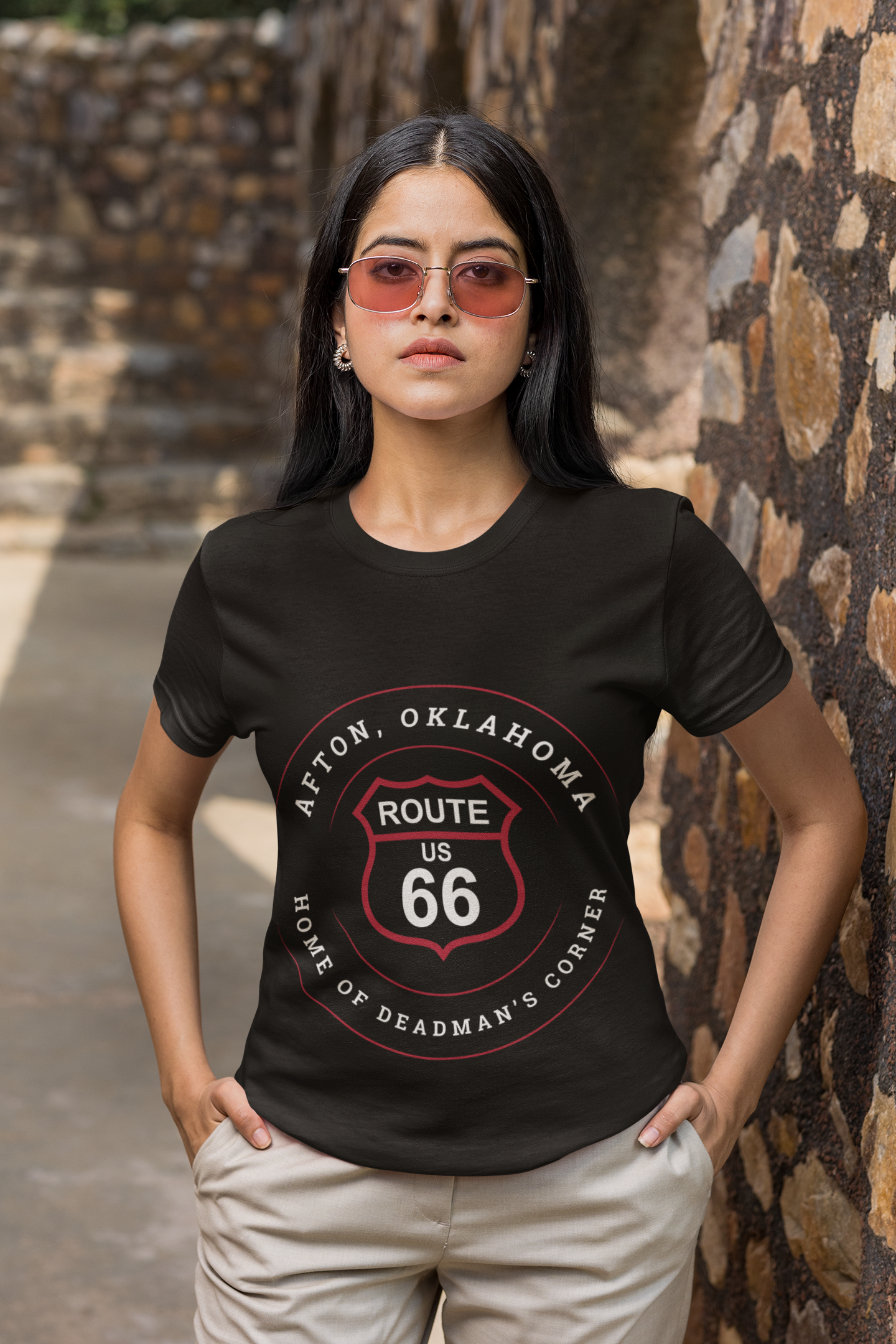 Female model wearing black heather retro Route 66 unisex jersey tee with Afton, OK "Home of Deadman's Corner"  design