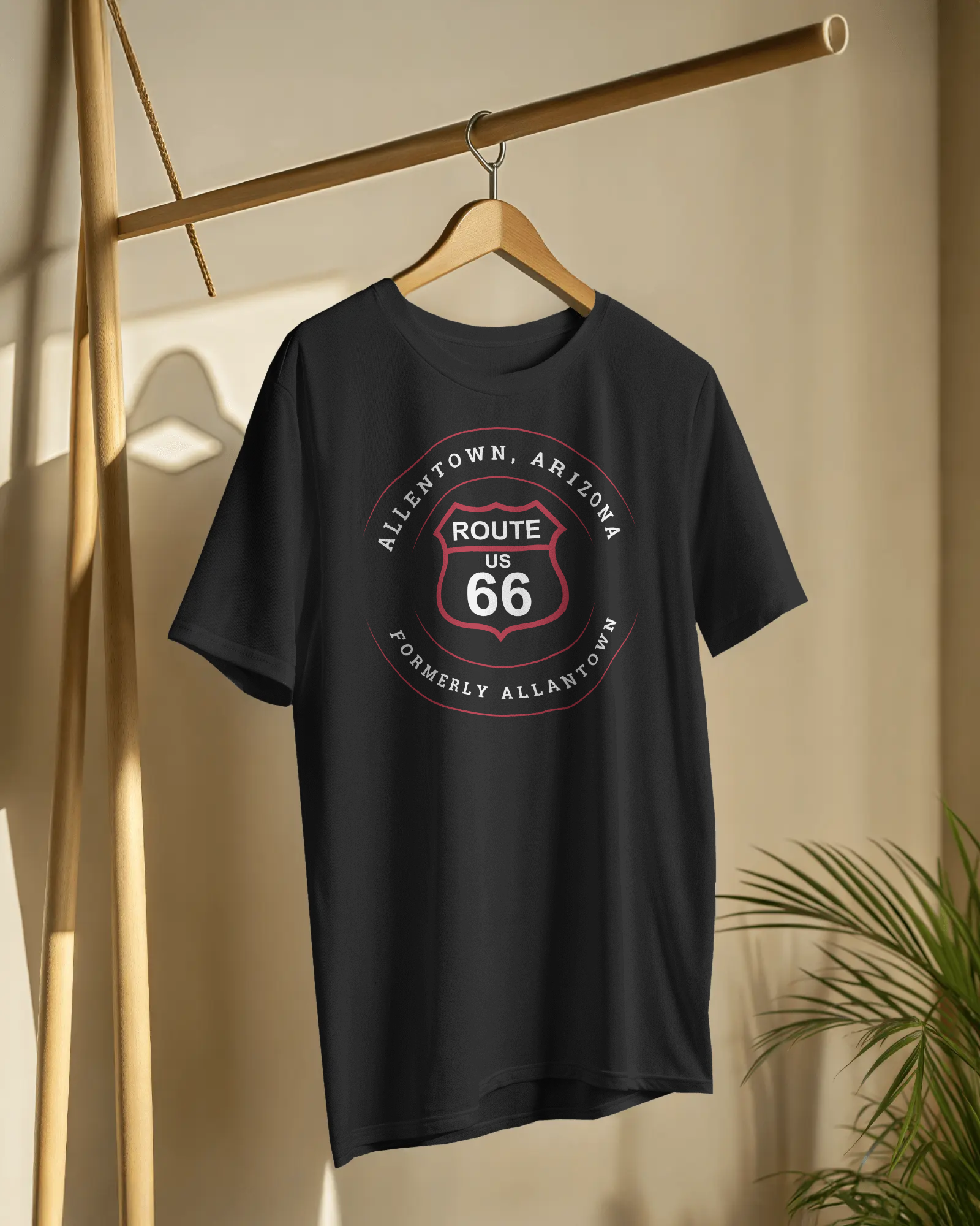 Vintage black retro Route 66 unisex jersey tee with Allentown, AZ: "Formerly Allantown" design hangin on a wooden hanger 
	