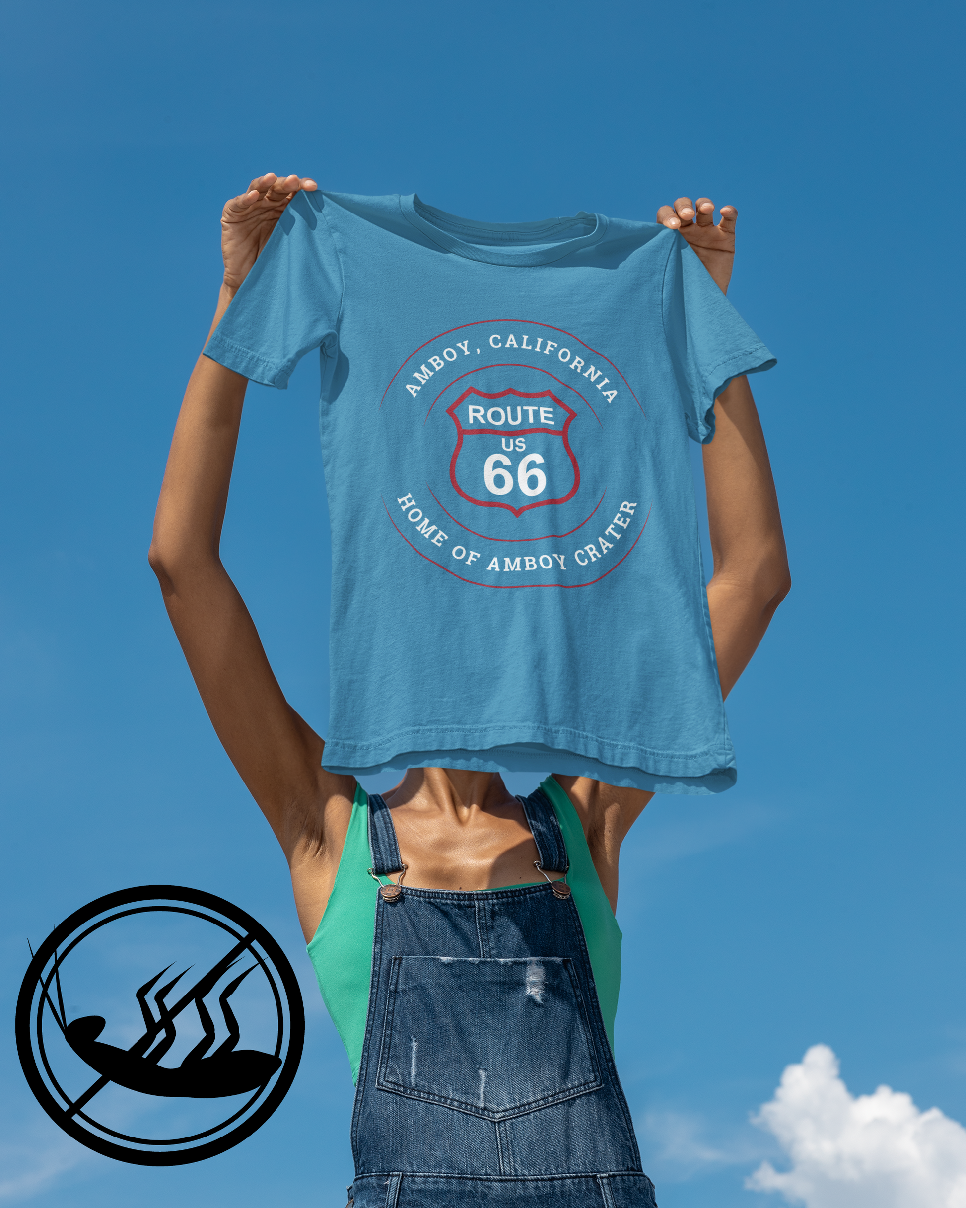 Female model holding a aqua retro Route 66 unisex jersey tee with Amboy, CA: "Home of Amboy Crater" design
