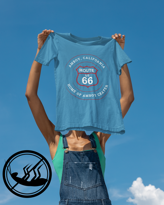 Female model holding a aqua retro Route 66 unisex jersey tee with Amboy, CA: "Home of Amboy Crater" design