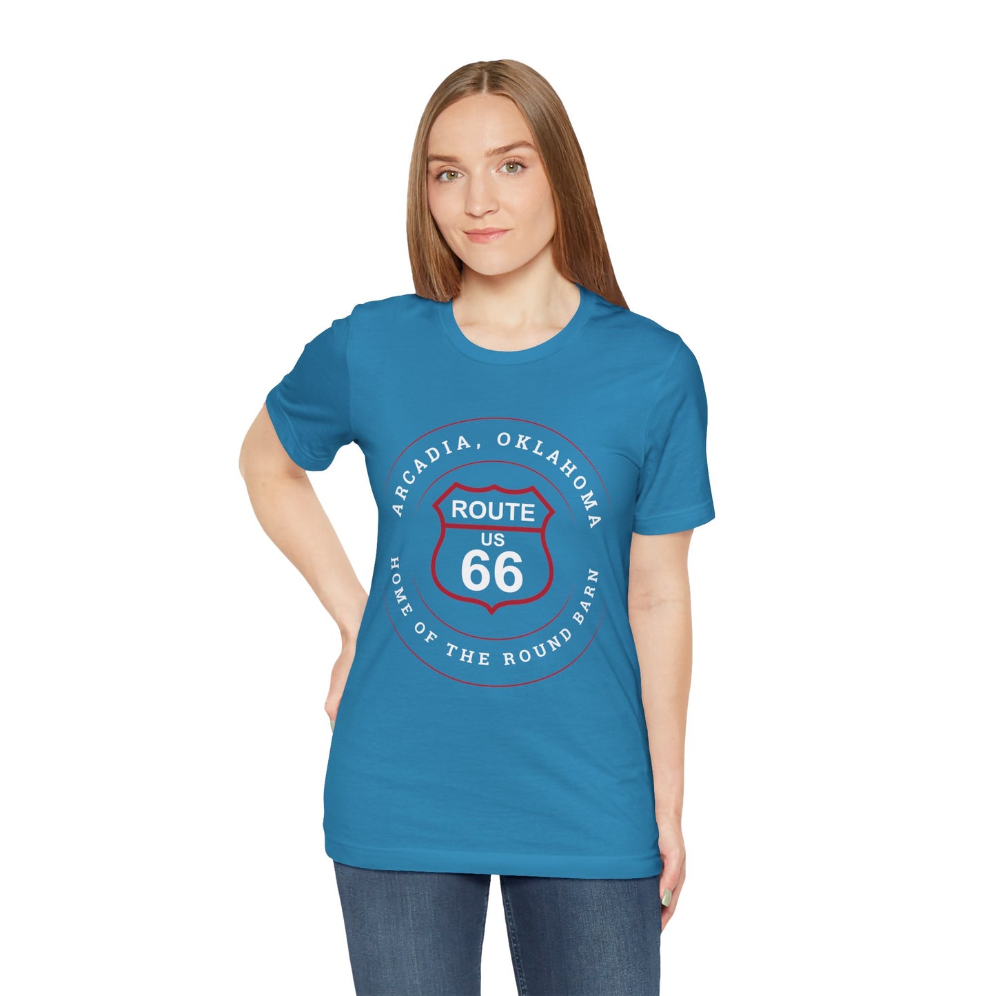 Female model wearing an aqua retro Route 66 unisex jersey tee with Arcadia, OK "Home of the Round Barn" design