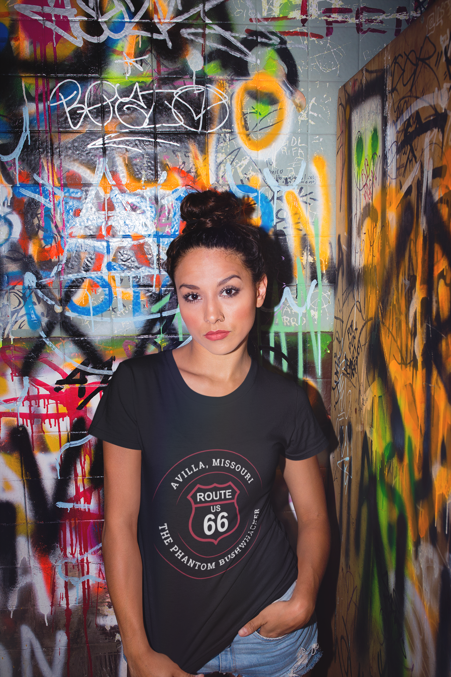Woman wearing a black retro Route 66 unisex jersey tee with Avilla, MO "The Phantom Bushwhacker" design