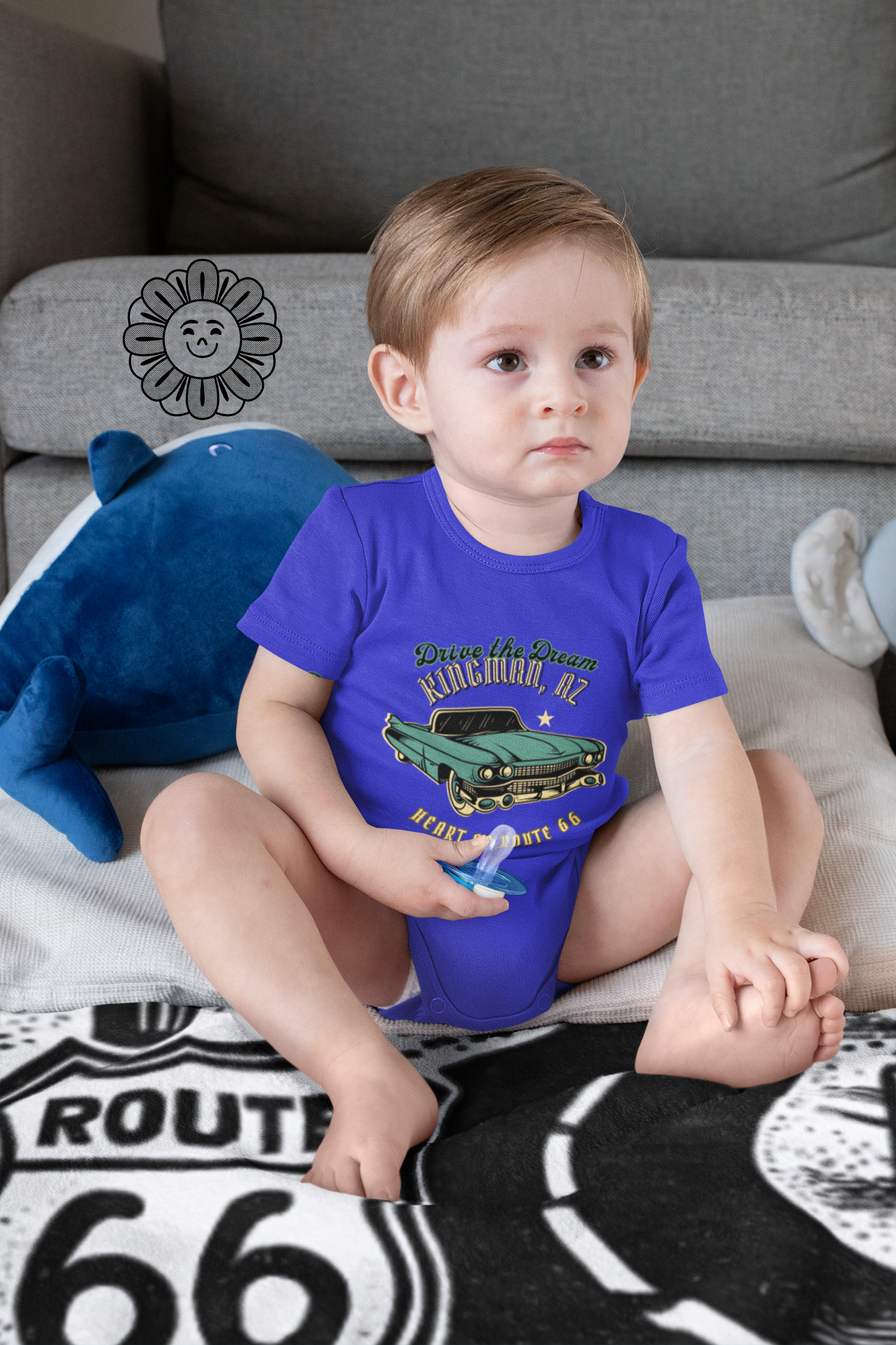Baby wearing true royal Route 66 vintage car bodysuit with Kingman AZ Heart of Route 66 design, sitting on a Mother Road blanket