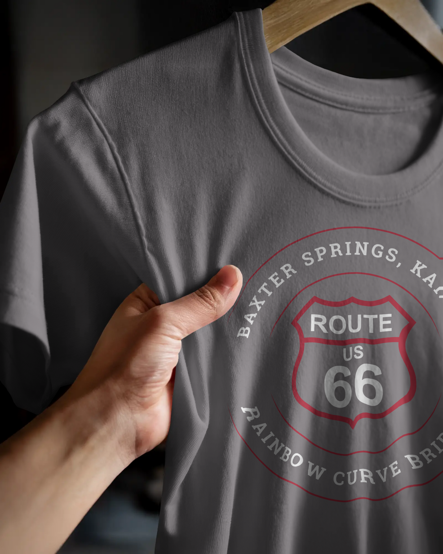 A hanging dark grey heather retro Route 66 unisex jersey tee with Baxter Springs, KS "Rainbow Curve Bridge" design