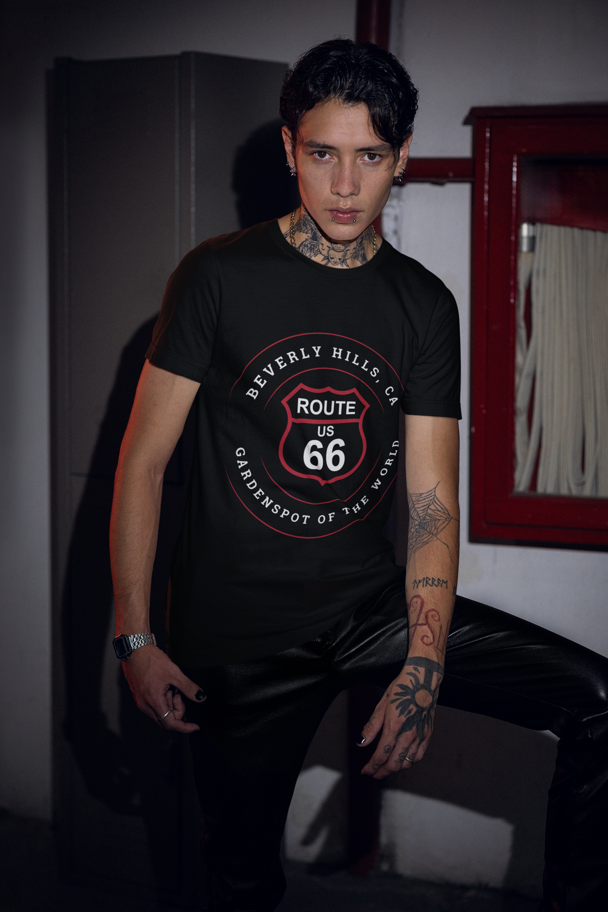 Male model with tattoos wearing black retro Route 66 unisex jersey tee with Beverly Hills, CA: "Gardenspot Of The World" design