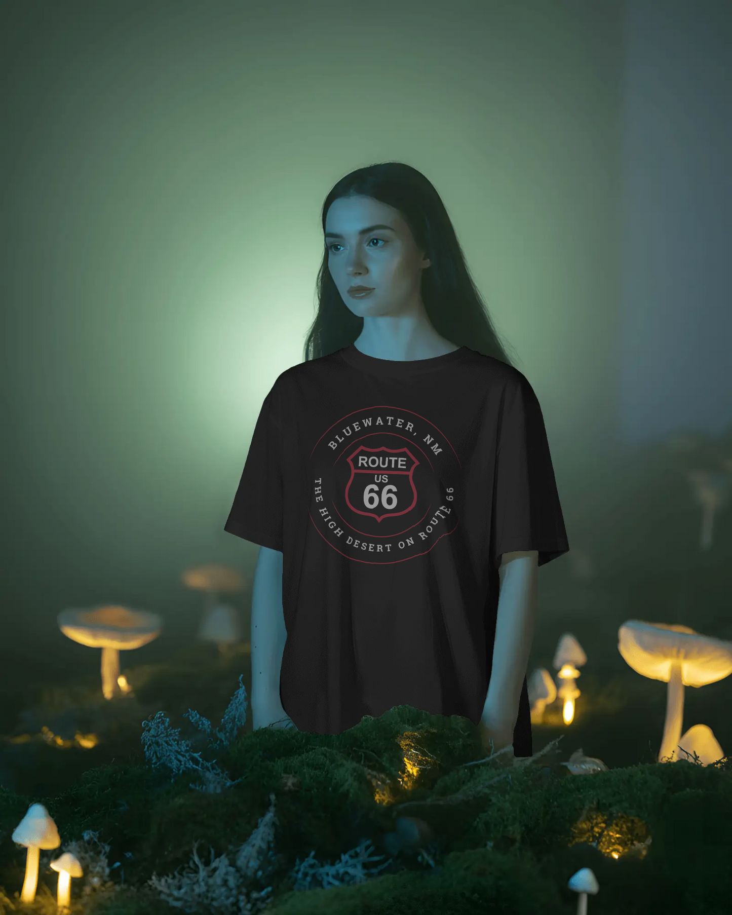 Female model wearing black heather retro Route 66 unisex jersey tee with Bluewater, NM: The High Desert on Route 66 graphic