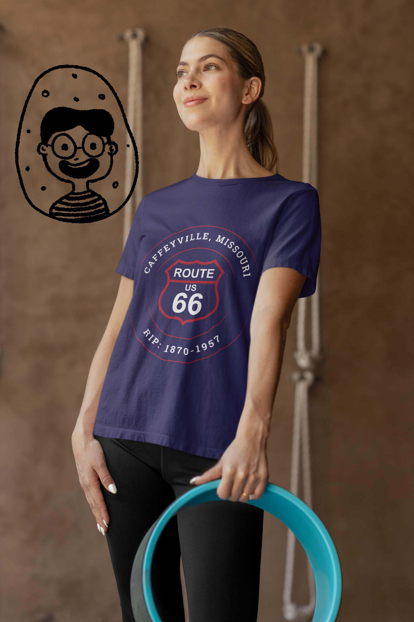 Female model wearing a team navy retro Route 66 unisex jersey tee with a Caffeyville, MO "RIP 1870-1957" design