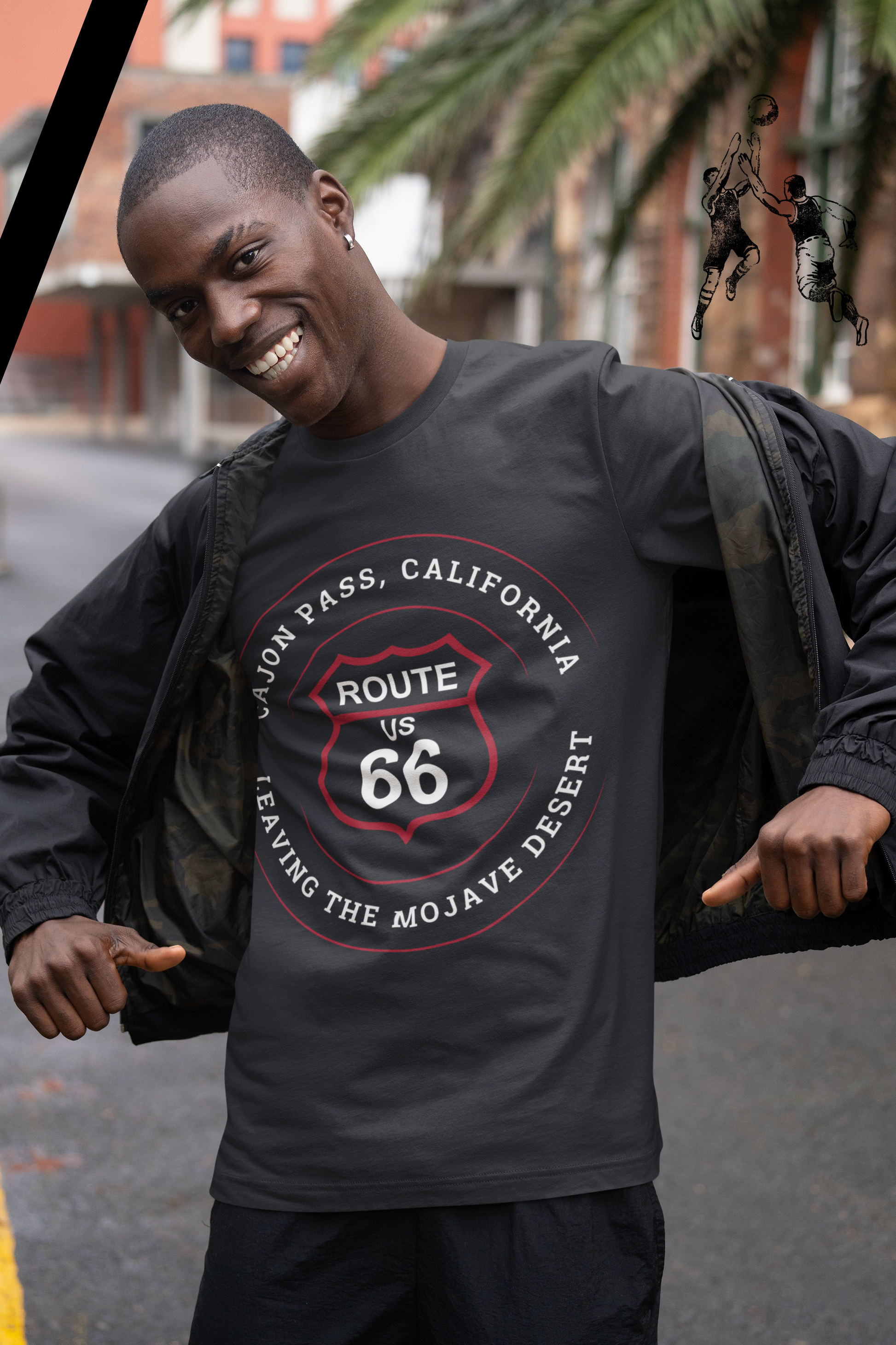 Male model wearing vintage black retro Route 66 unisex jersey tee with Cajon Pass, CA: "Leaving the Mojave Desert" design