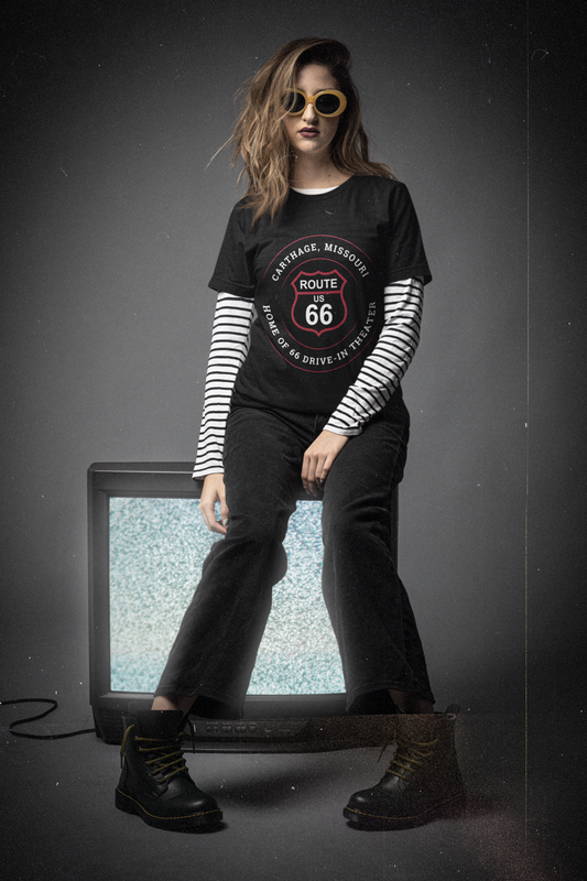 Female model wearing black heather retro Route 66 unisex jersey tee with Carthage, MO "Home of 66 Drive-in Theater" design