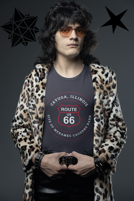 Male model wearing a black retro Route 66 unisex jersey tee with a Cayuga, IL: "Site of Meramec Caverns Barn" design
