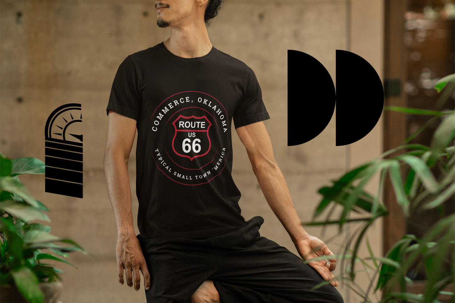 Person wearing a black retro Route 66 unisex jersey tee with Commerce, OK "Typical Small Town 'Merica"  design. 