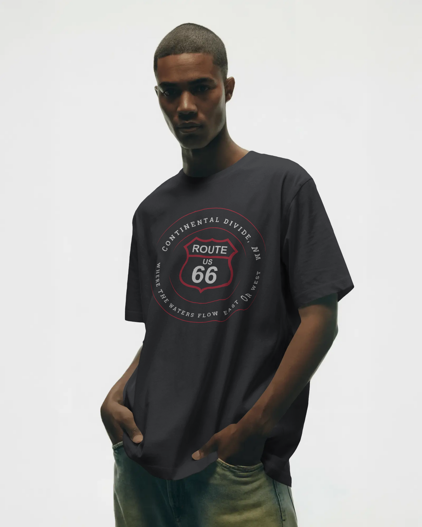 Male model wearing black heather retro Route 66 unisex jersey tee with Continental Divide, NM: Where the Water Flows East or West graphic.