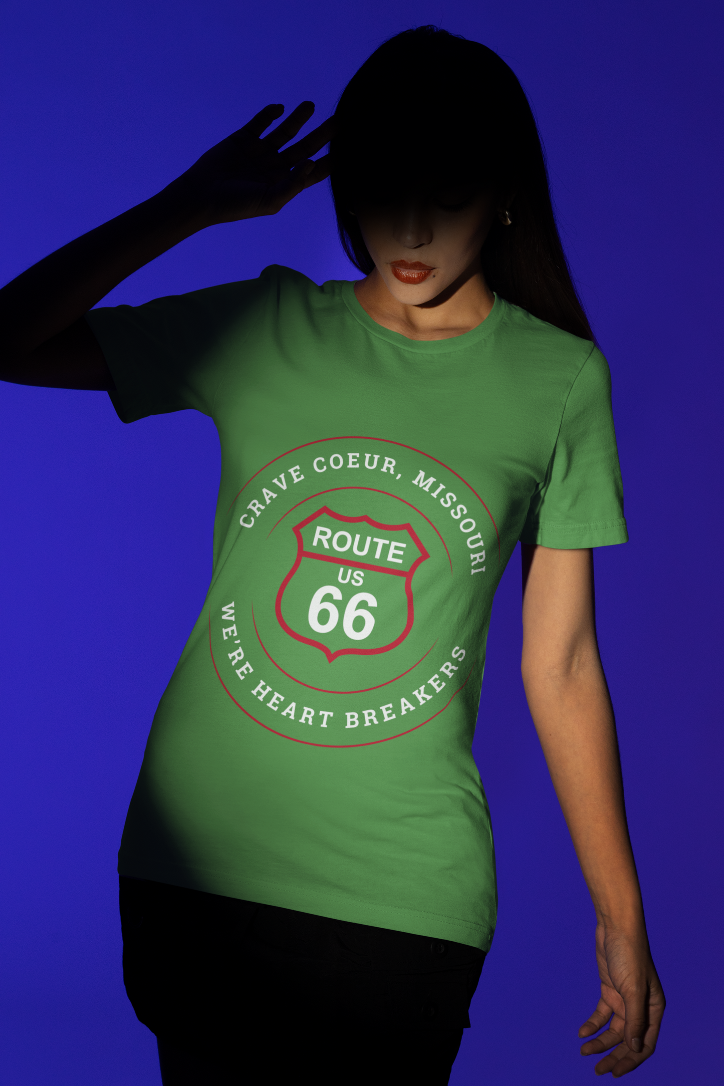Female model, whose face is concealed by a shadow, is wearing a leaf retro Route 66 unisex jersey tee with a Creve Coeur, MO: "We're Heart Breakers" design