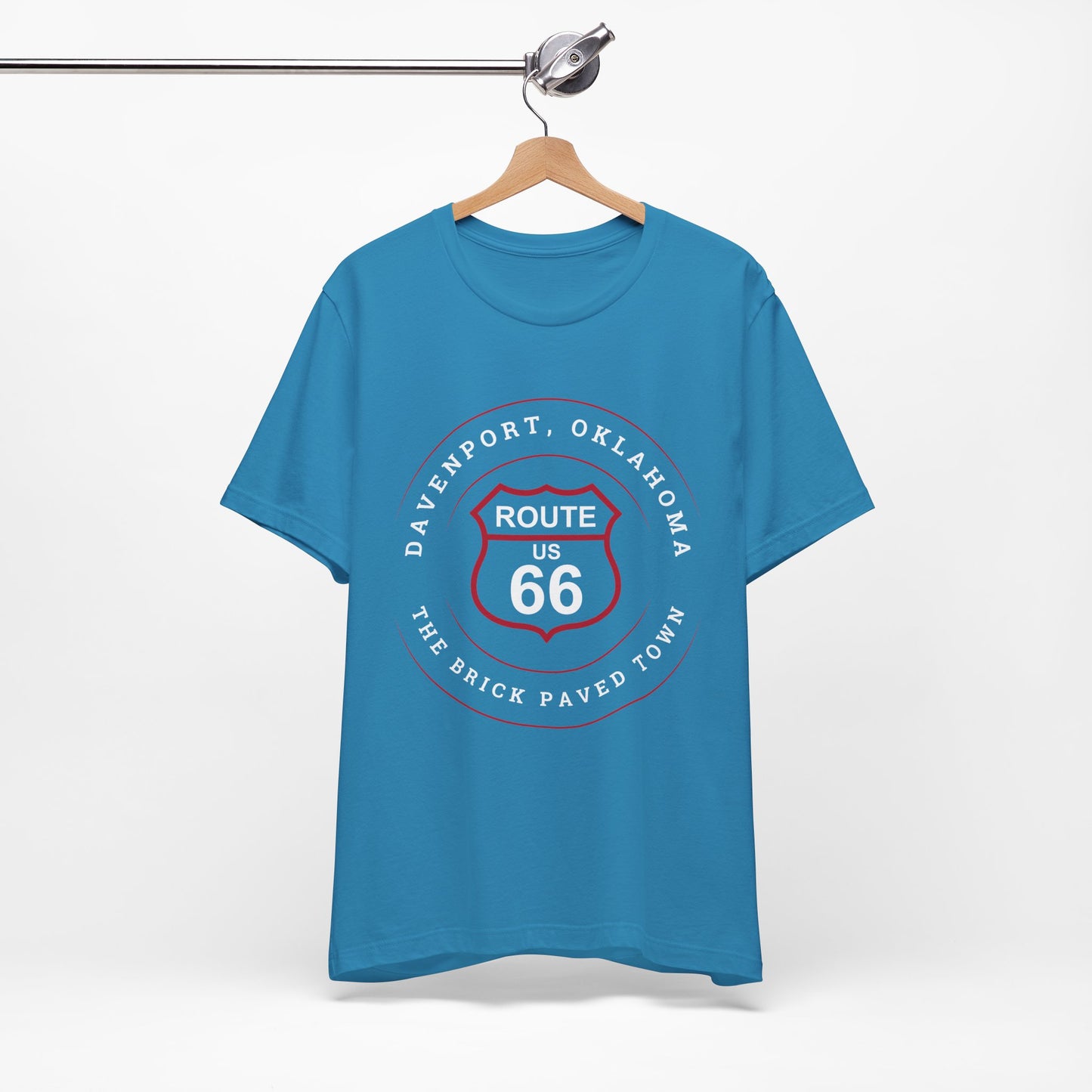 Aqua retro Route 66 unisex jersey tee with Davenport, OK "The Brick-Paved Town" design displayed on a wooden hanger