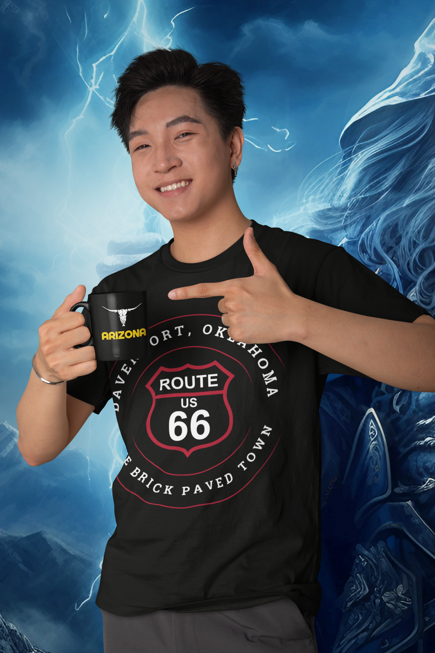 Male model drinking a cappuccino out of a black and yellow Arizona mug with a sheephorn skull displayed. He is wearing black retro Route 66 unisex jersey tee with Davenport, OK "The Brick-Paved Town" design