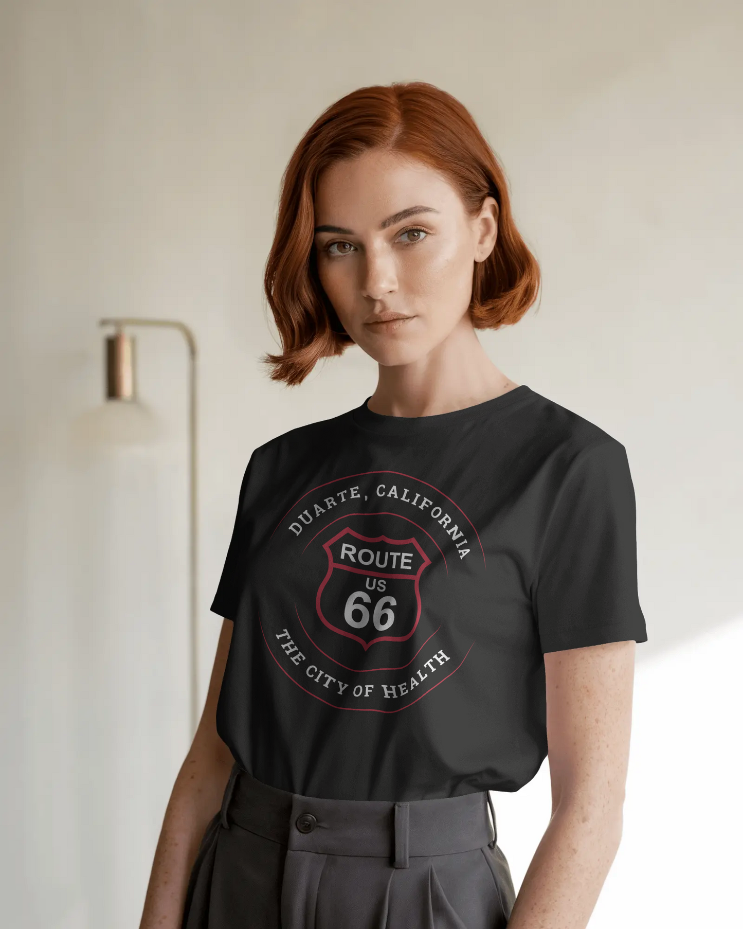 Female model wearing black heather retro Route 66 unisex jersey tee with Duarte, CA: "The City of Health" design