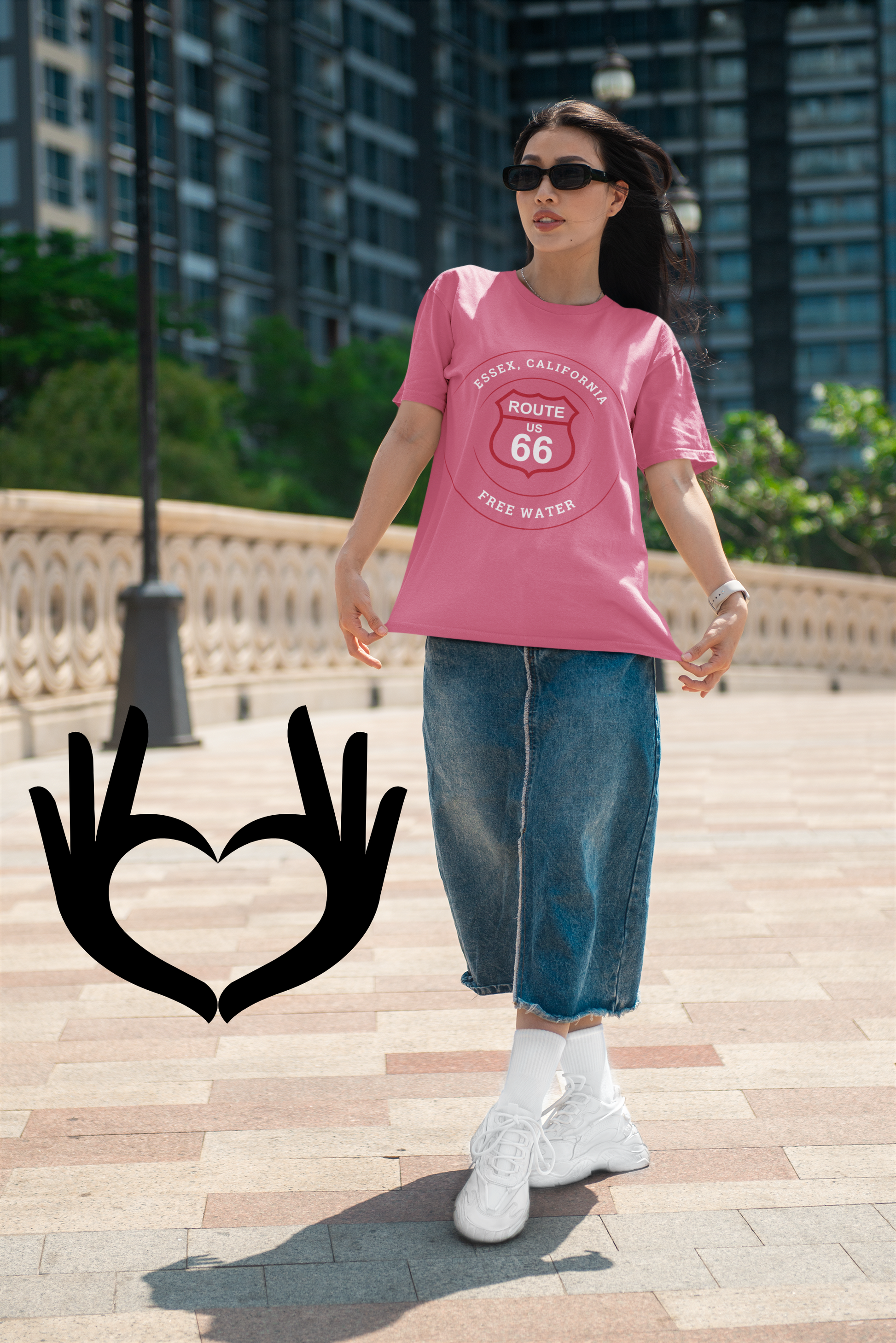 Female model wearing heather raspberry retro Route 66 unisex jersey tee with Essex, CA: "Free Water" design