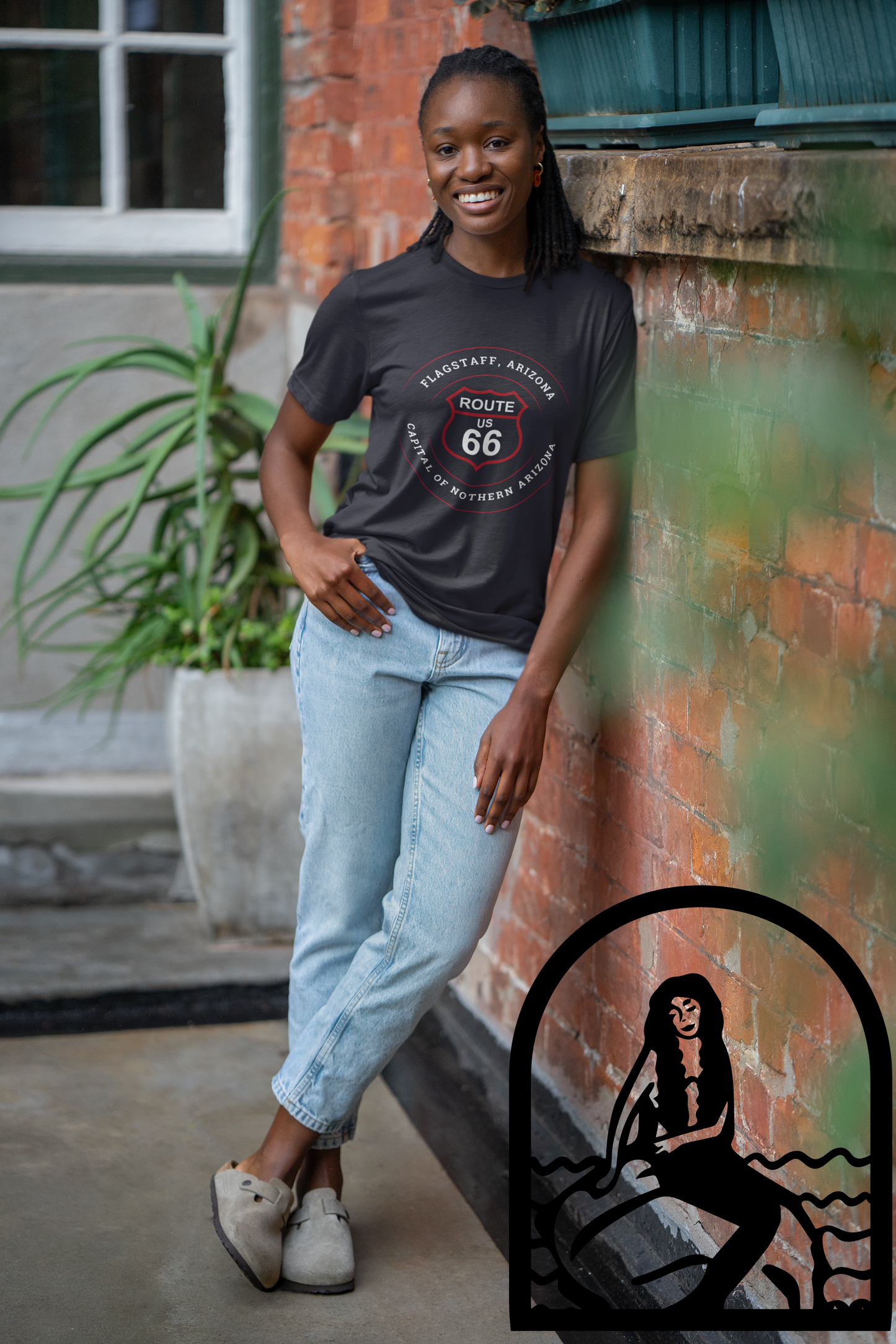 Female model wearing black retro Route 66 unisex jersey tee with Flagstaff, AZ: "Capital of Northern Arizona" design