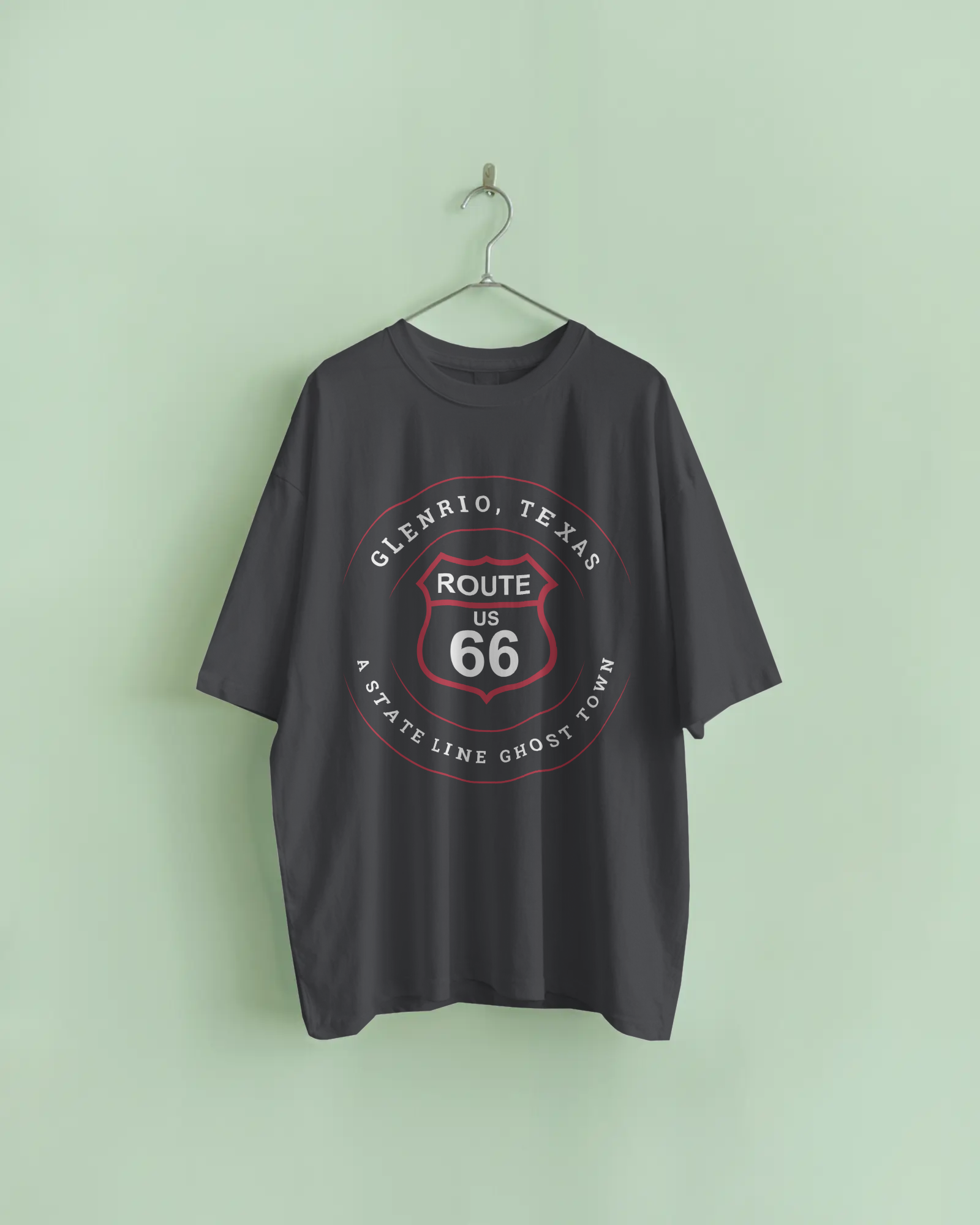 Vintage black retro Route 66 unisex jersey tee with Glenrio, TX: A State Line Ghost Town on metal hanger