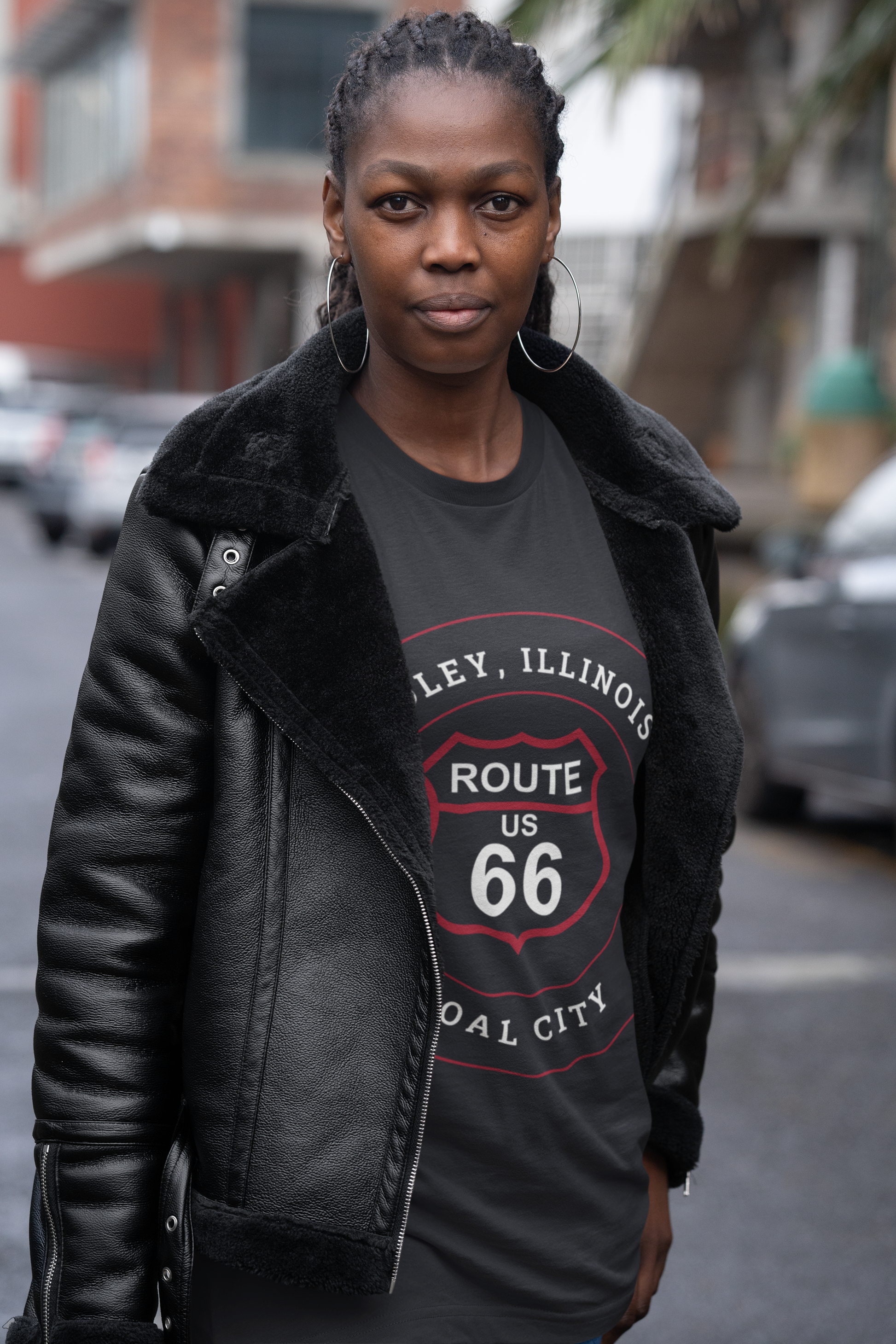 Female model wearing a vintage black retro Route 66 unisex jersey tee with a Godley, IL: "Coal City" design