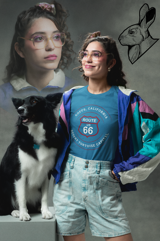 Female model, in a yearbook-style photo, who is wearing a aqua retro Route 66 unisex jersey tee with Goffs, CA: "Desert Tortoise Capital" design