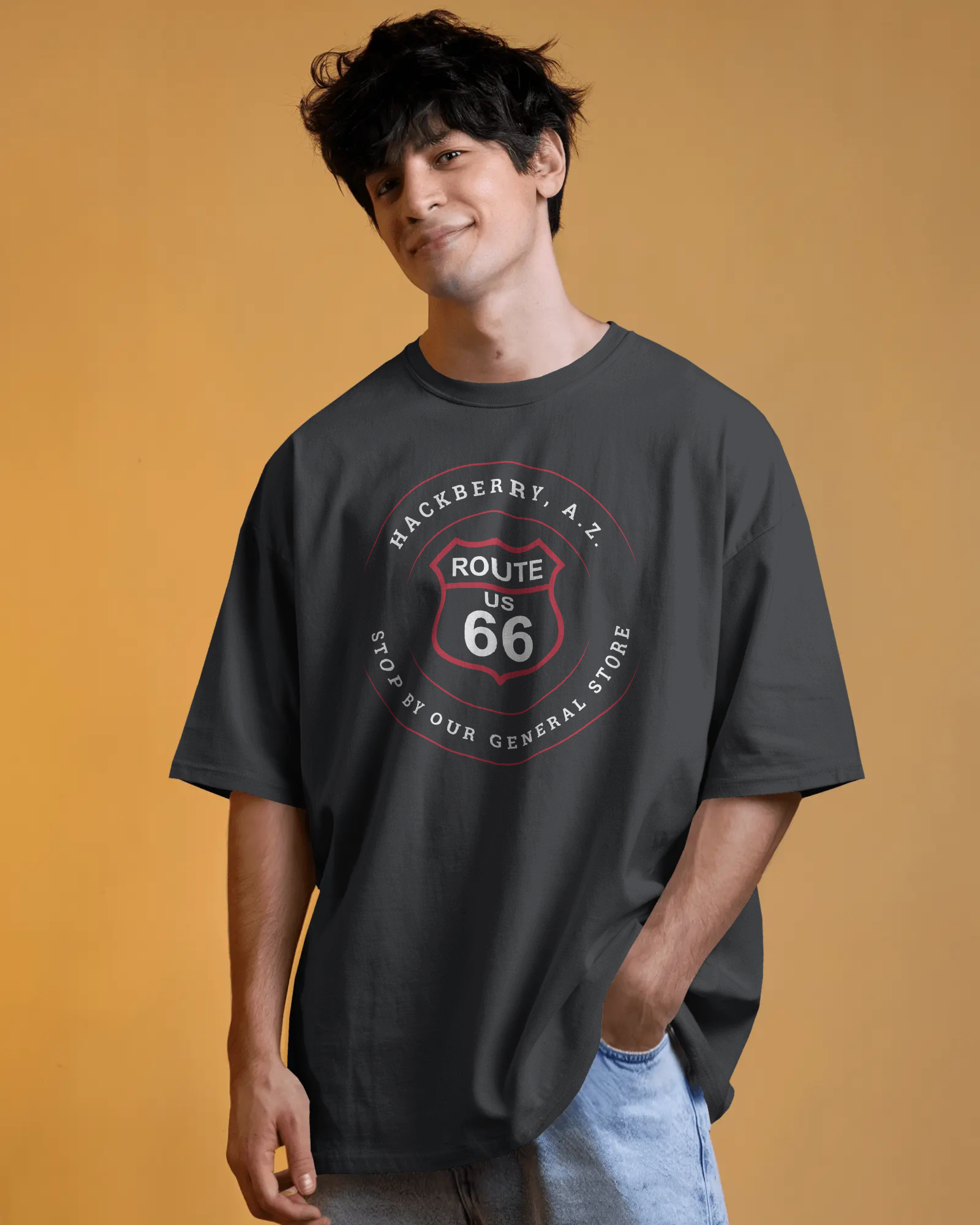 Female model wearing black heather retro Route 66 unisex jersey tee with Hackberry, AZ: "Stop by our General Store" design