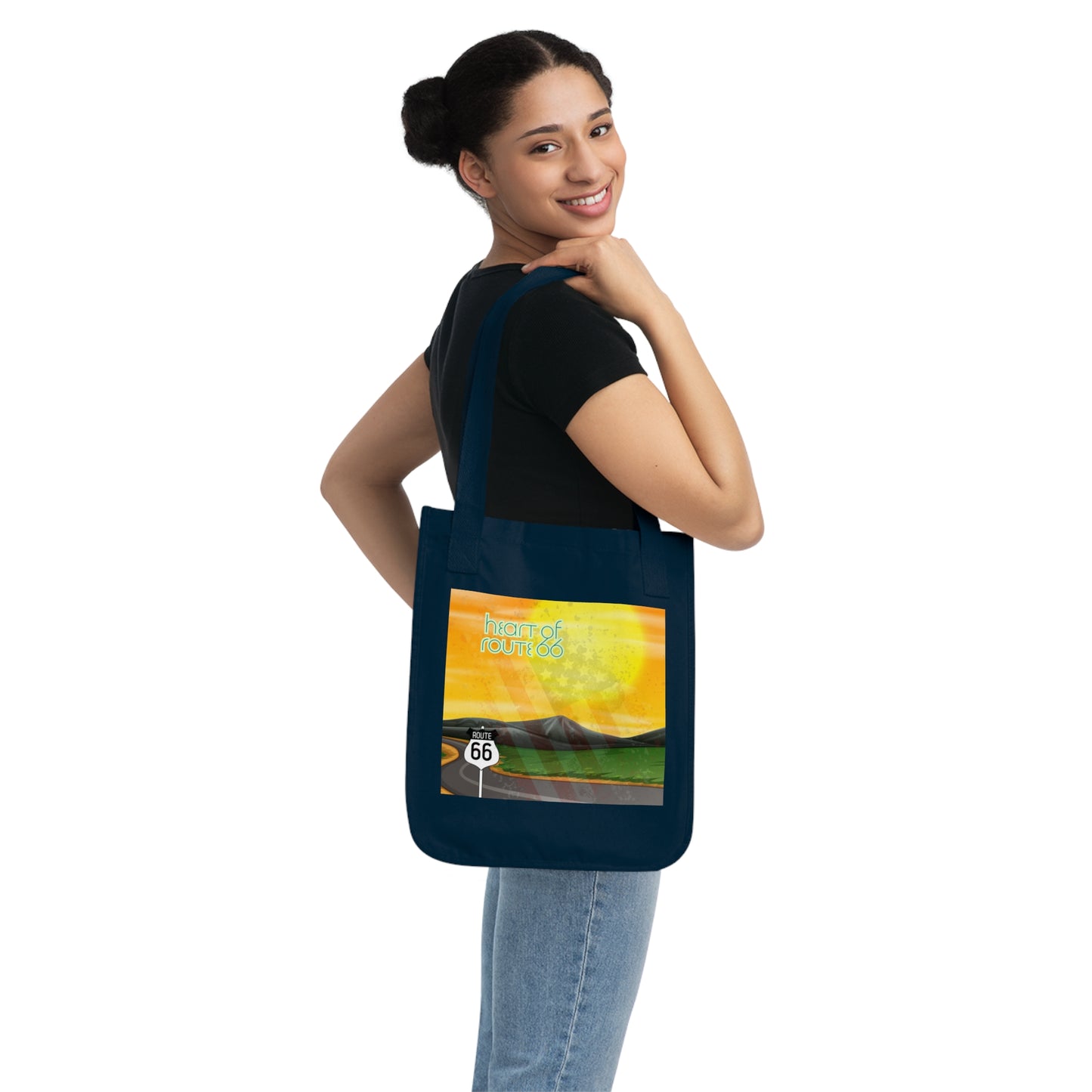 Smiling woman wearing a black organic tote bag, with a Heart of Route 66 graphic, over her shoulder.