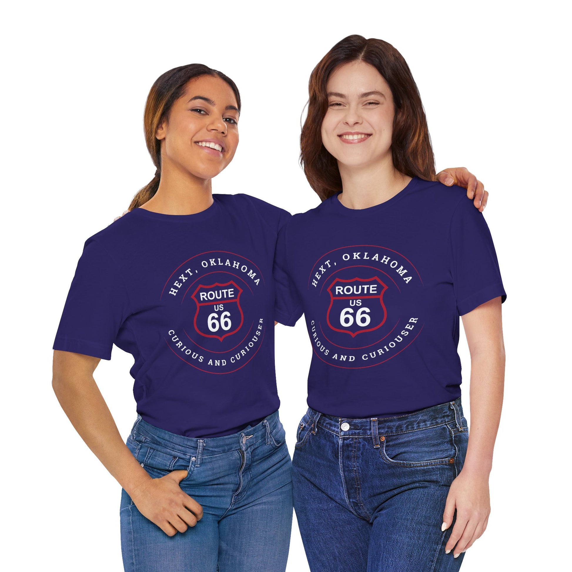 Two female models wearing matching team navy retro Route 66 unisex jersey tee with Hext, OK: "Curious and Curiouser" design