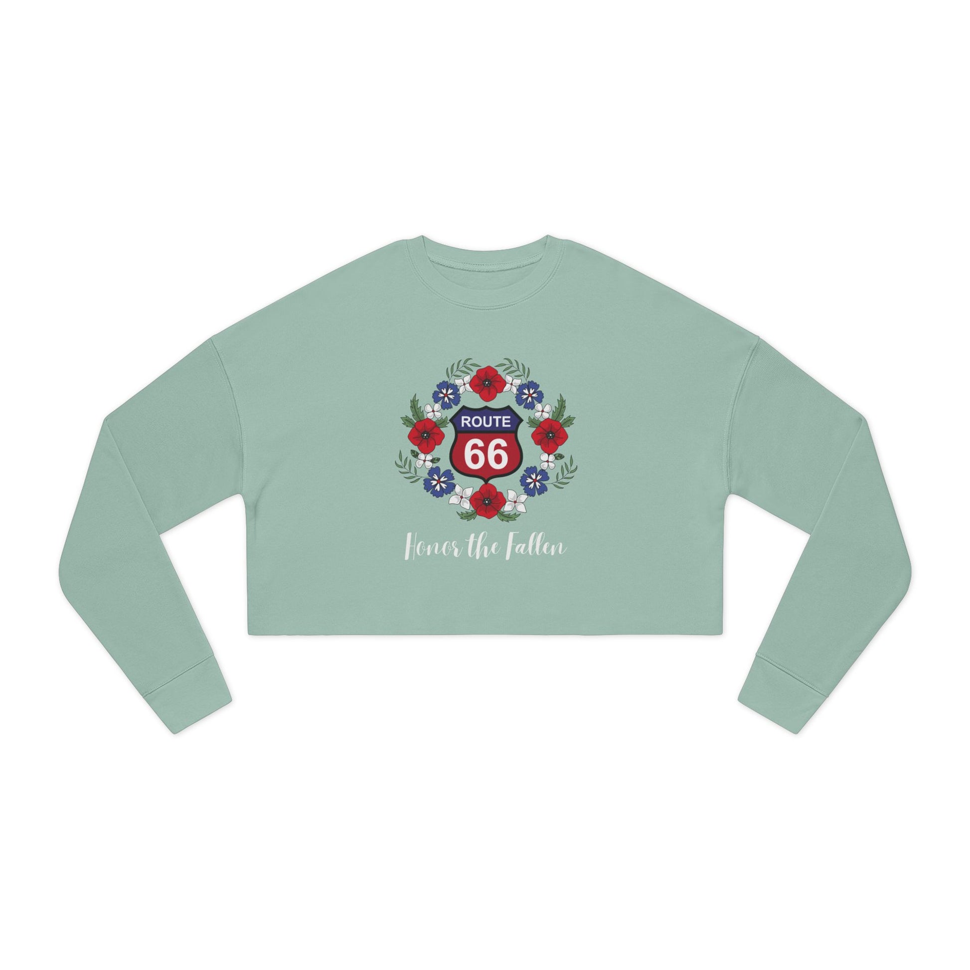 Flat lay of dusty blue cropped Route 66 “Honor the Fallen” sweatshirt featuring red Route 66 shield surrounded by a poppy wreath and the phrase “Honor the Fallen” is written beneath the design
