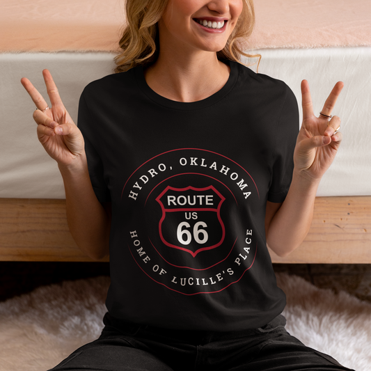 Female model wearing black retro Route 66 unisex jersey tee with Hydro, OK "Home of Lucille's Place" design