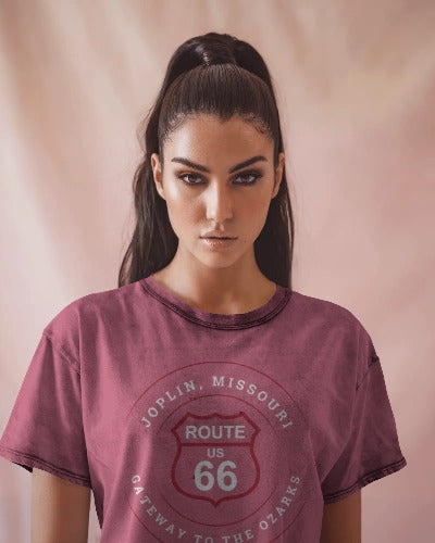 Female model wearing heather team purple retro Route 66 unisex jersey tee with Joplin, MO "Gateway to the Ozarks" design