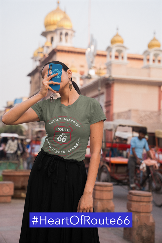 Female model wearing a heather military green retro Route 66 unisex jersey tee with a Laquey, MO: It’s Pronounced "Lakeway" design