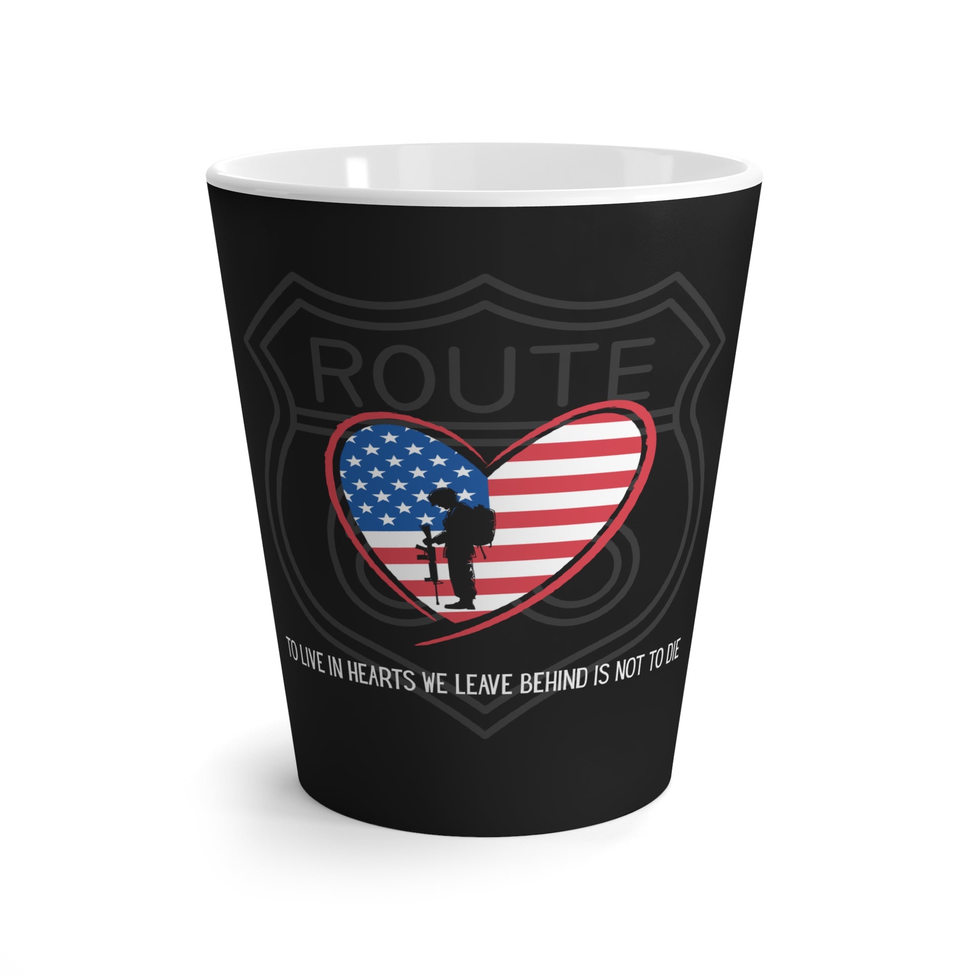 A flat lay of a black Route 66 latte mug with a heart-shaped US flag, a Route 66 shield and a Thomas Campbell quote.