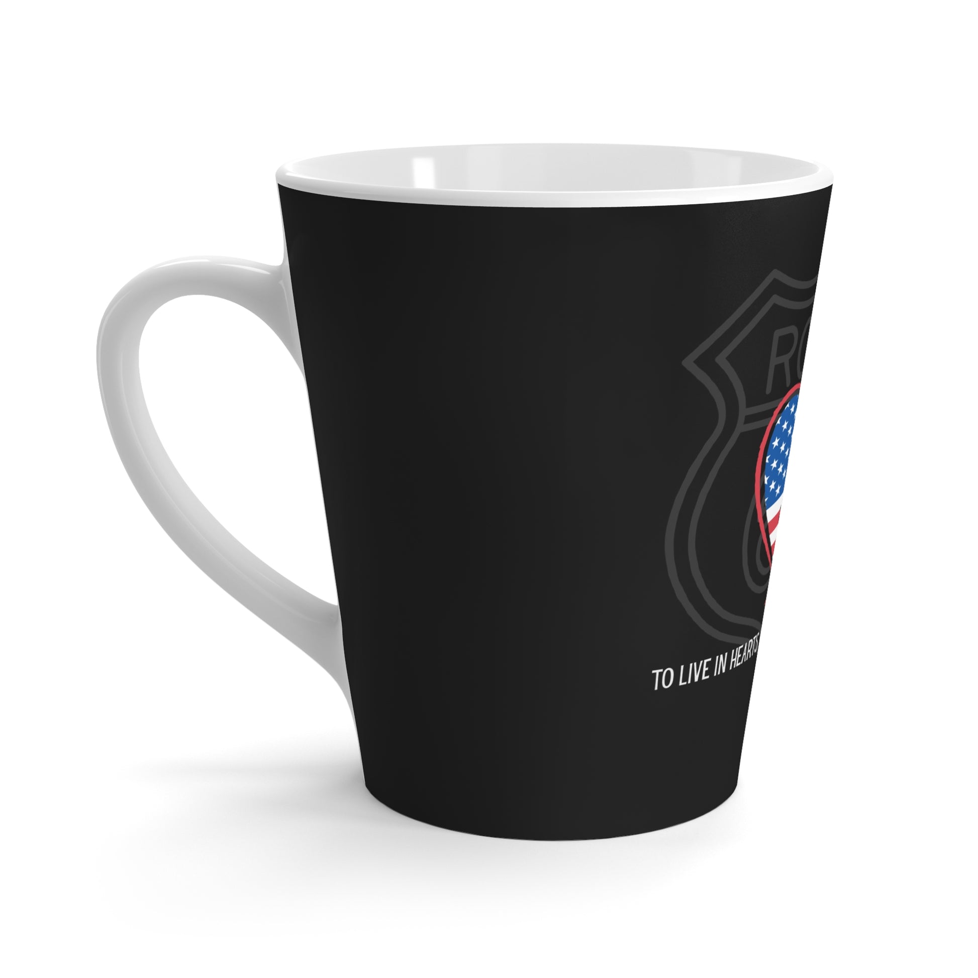 Side view of a black Route 66 latte mug with a heart-shaped US flag, a Route 66 shield and a Thomas Campbell quote.