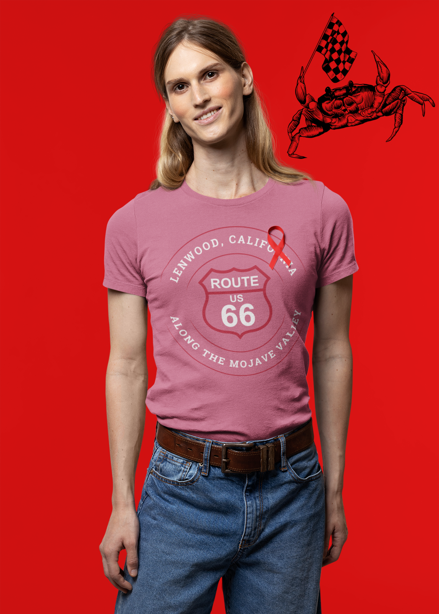 Male model wearing heather raspberry retro Route 66 unisex jersey tee with Lenwood, CA: "Along the Mojave Valley" design against a red background with a crab holding a race flag illustration in the top right corner
