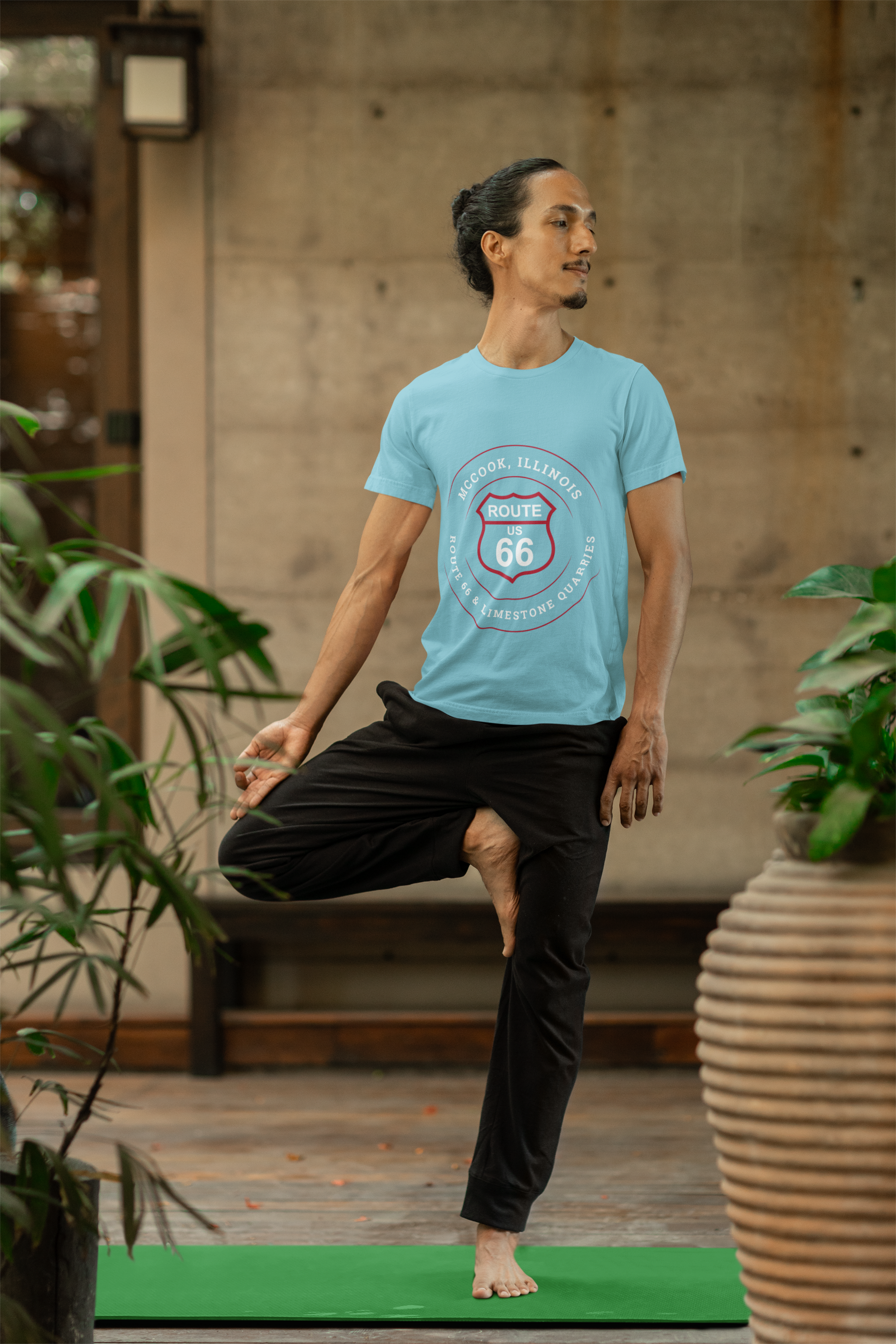 Male model wearing a black retro Route 66 unisex jersey tee with a McCook, IL: "Route 66 and Limestone Quarries" design