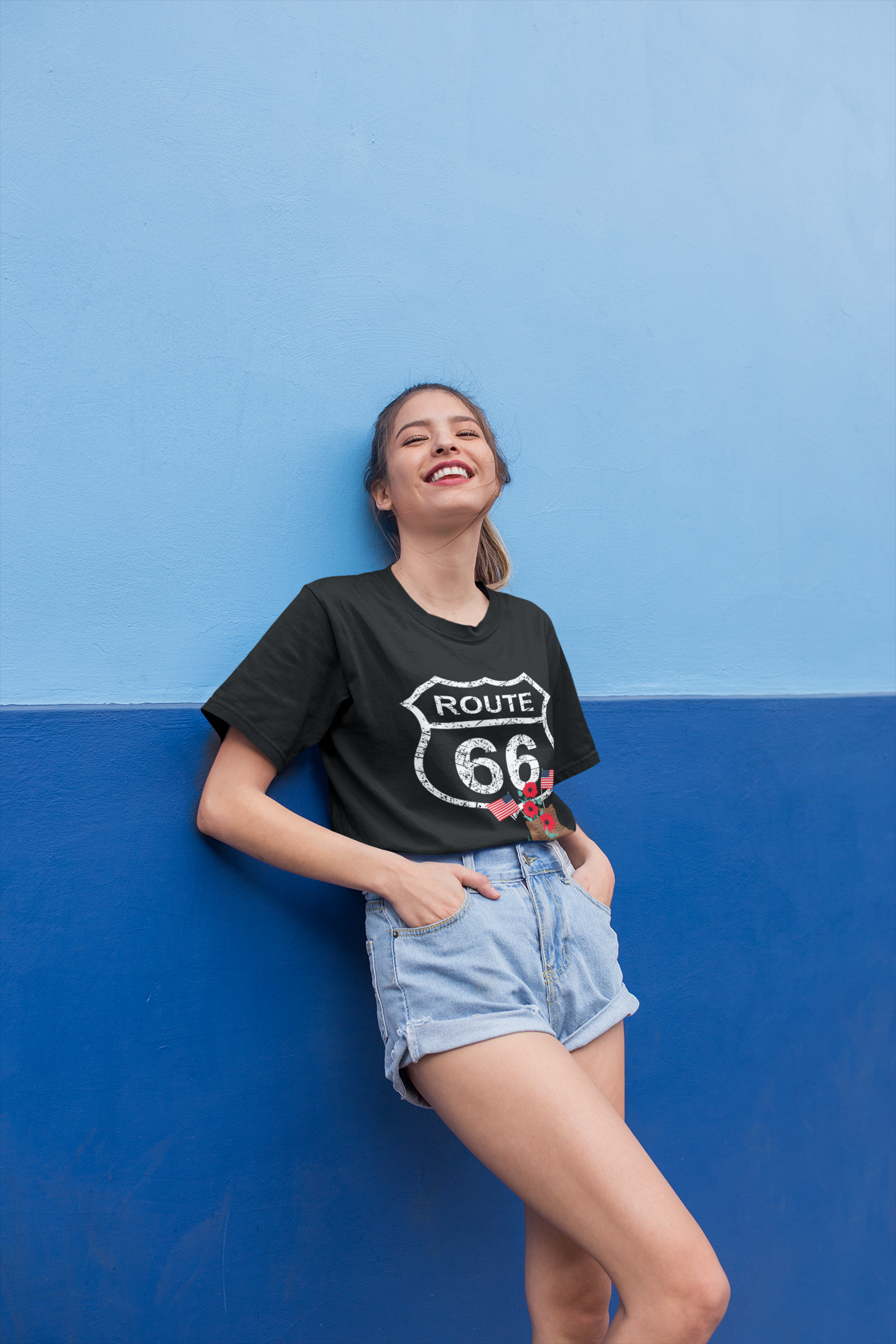Laughing woman wearing a black Route 66 Memorial Day Tee featuring distressed shield, combat boots, red poppies and American flags - patriotic tribute design.