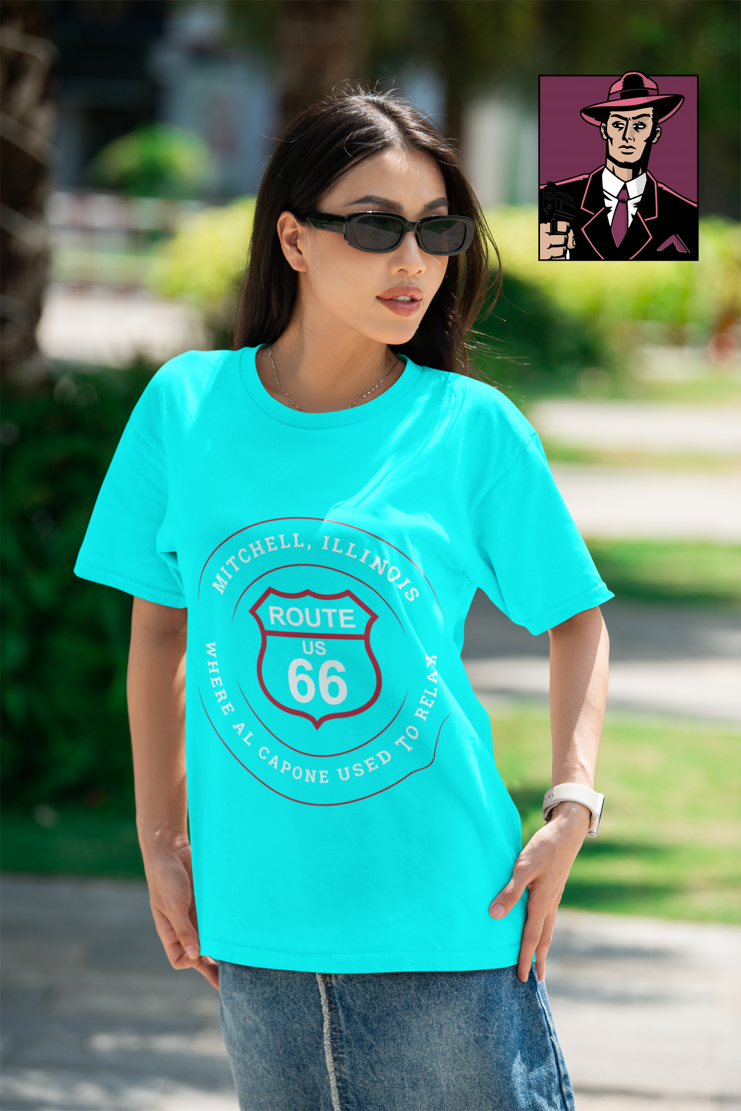 Female model wearing a turquoise retro Route 66 unisex jersey tee with a Mitchell, IL:: "Where Al Capone Used to Relax" design