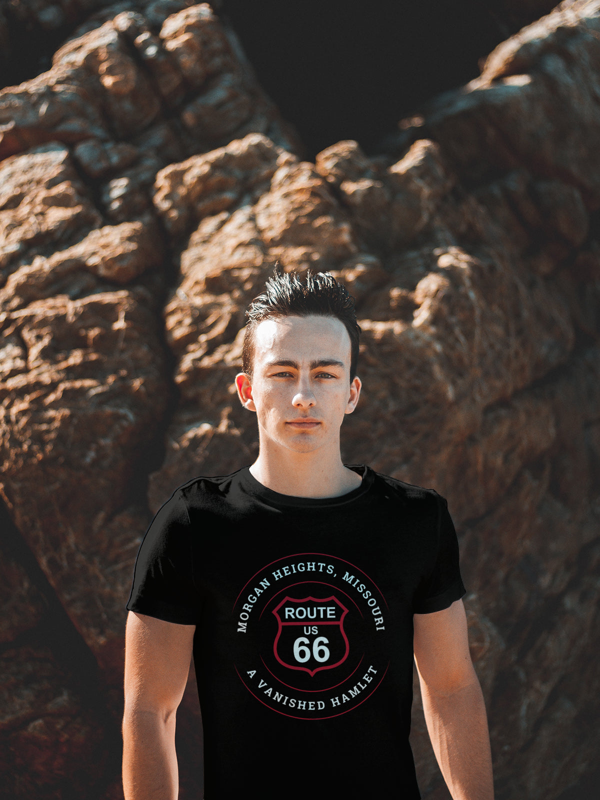 Male model wearing a black retro Route 66 unisex jersey tee with a Morgan Heights, MO: "A Vanished Hamlet" design