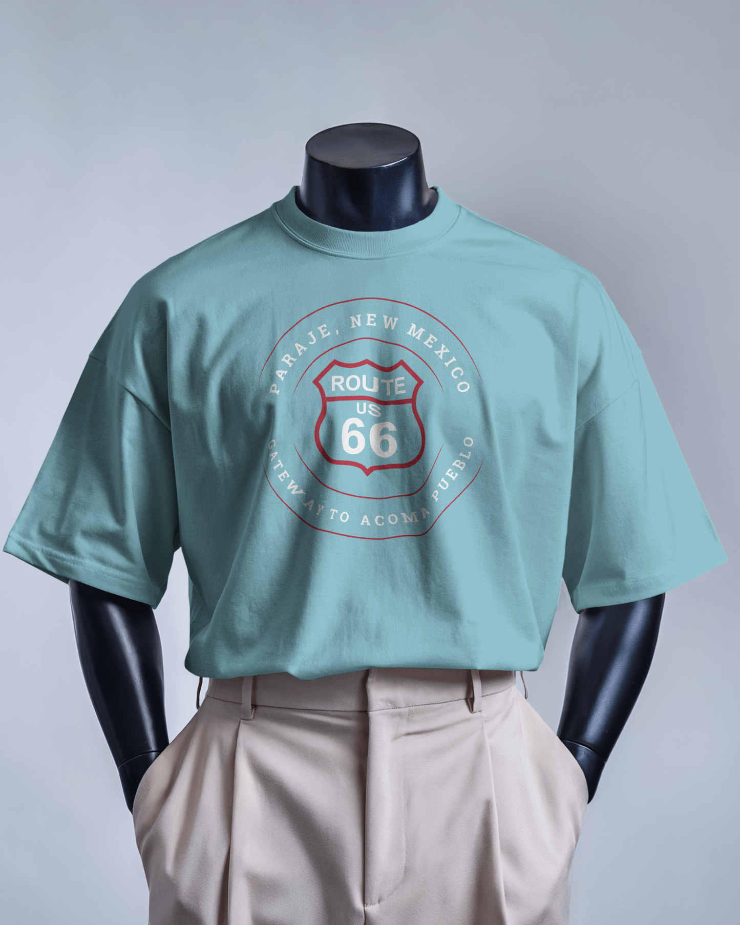 Mannequin model wearing black retro Route 66 unisex jersey tee with Paraje, NM: "Gateway to Acoma Pueblo" design