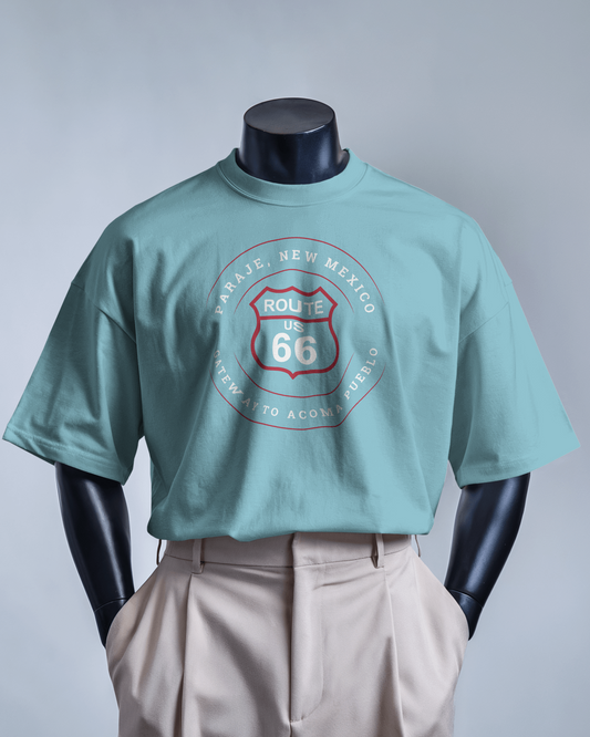 Mannequin model wearing black retro Route 66 unisex jersey tee with Paraje, NM: "Gateway to Acoma Pueblo" design